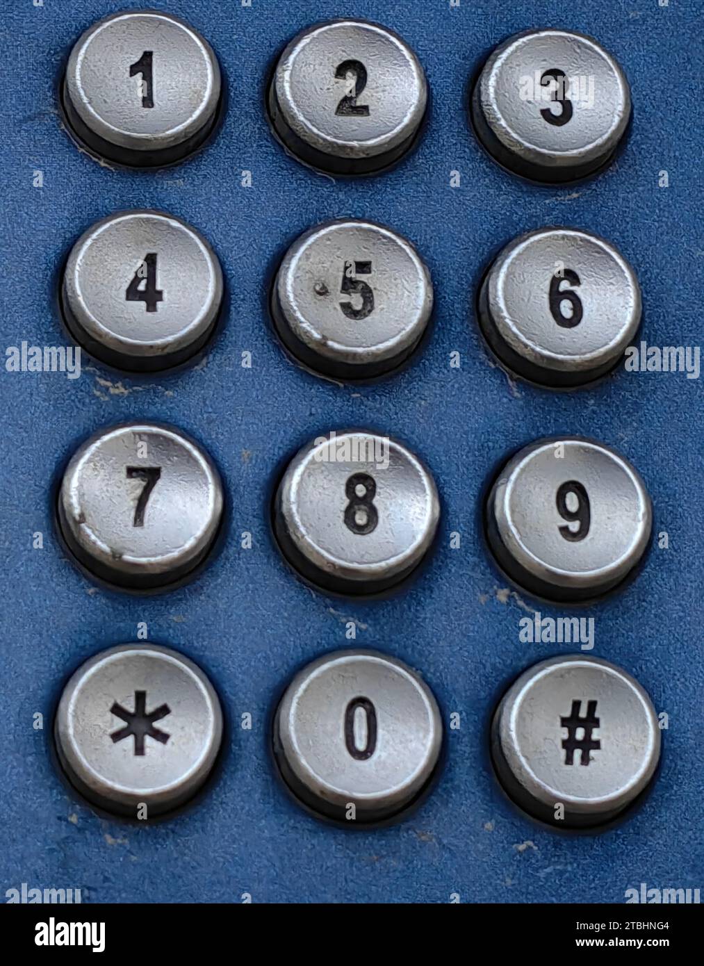 Tactile, digits. Part of the old phone. Silver Round shape. Blue background. Dial my number, concept. Stock Photo