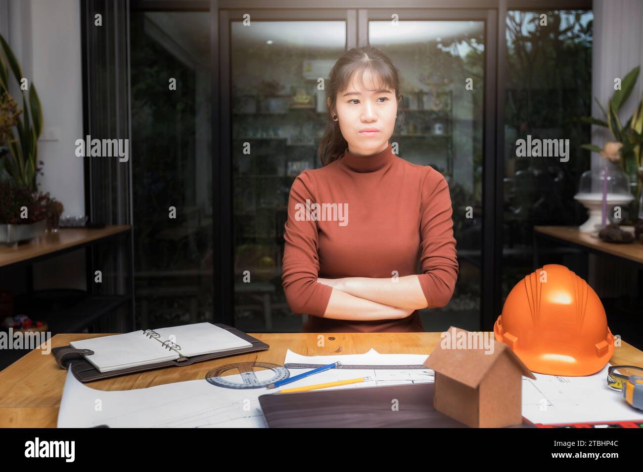Female architect working with new startup project and thinking about her project at home office. Stock Photo