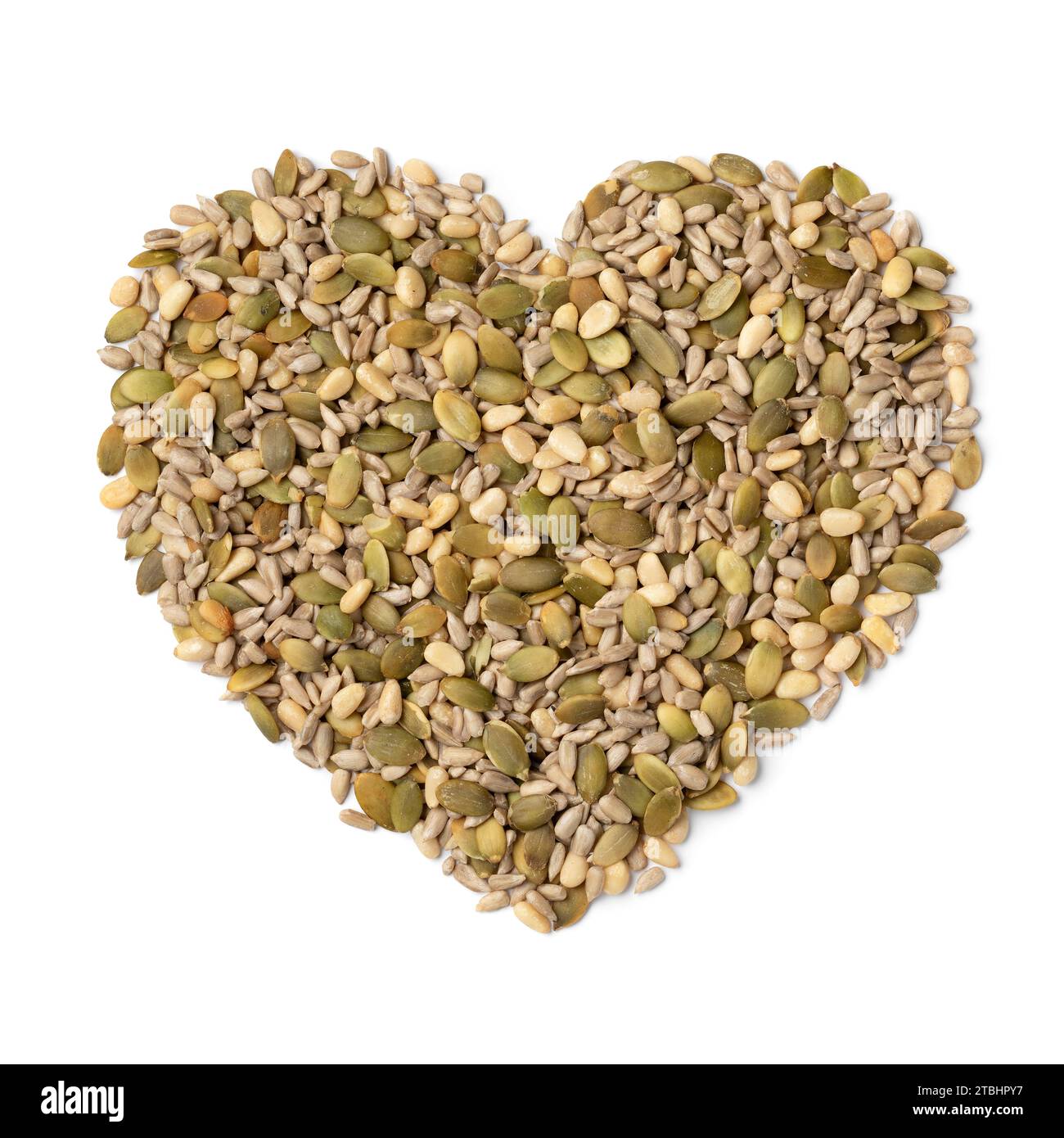 Mixture of dried salad seeds in heart shape isolated on white background close up Stock Photo