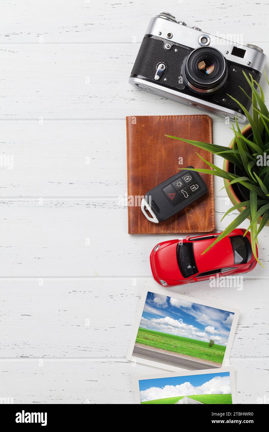Travel vacation concept with camera, passport, car toy and travel photos on wooden backdrop. Top view with copy space. Flat lay. All photos taken by m Stock Photo