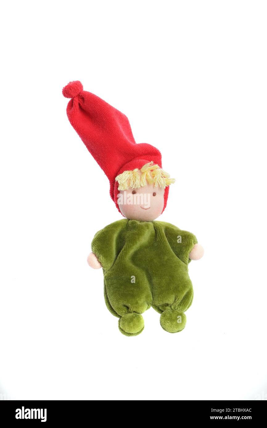 Green plush handmade baby toy in red hat isolated on white background ...