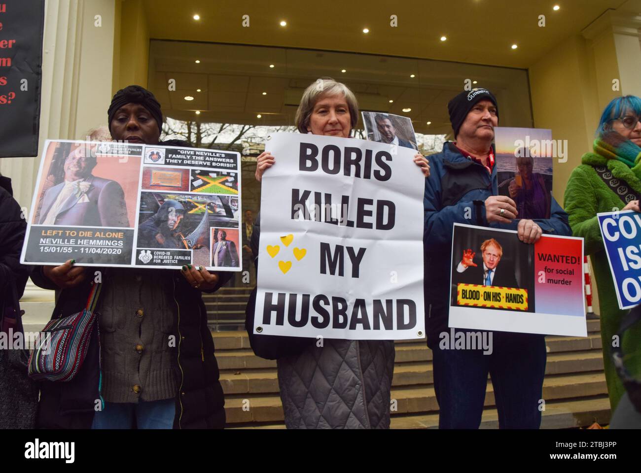 London, UK. 07th Dec, 2023. Protesters hold anti-Boris Johnson placards and pictures of victims of coronavirus during the demonstration. Protesters and bereaved family members gathered outside the Covid-19 Inquiry Hearing Centre as former prime minister Boris Johnson gave his testimony on the second day. Credit: SOPA Images Limited/Alamy Live News Stock Photo