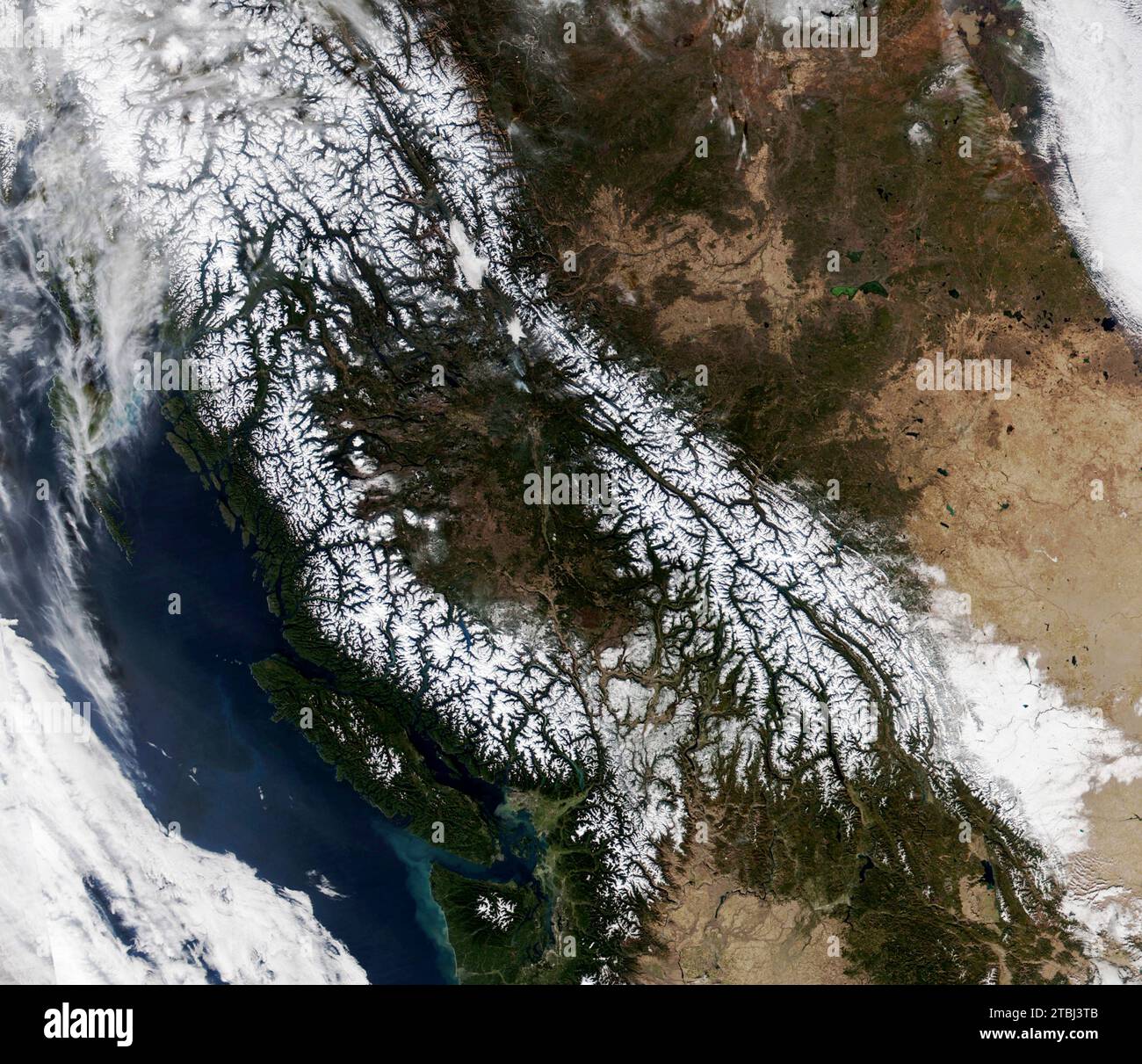 Satellite image of snowcapped peaks across numerous mountain ranges in British Columbia and western Alberta, Canada. Stock Photo