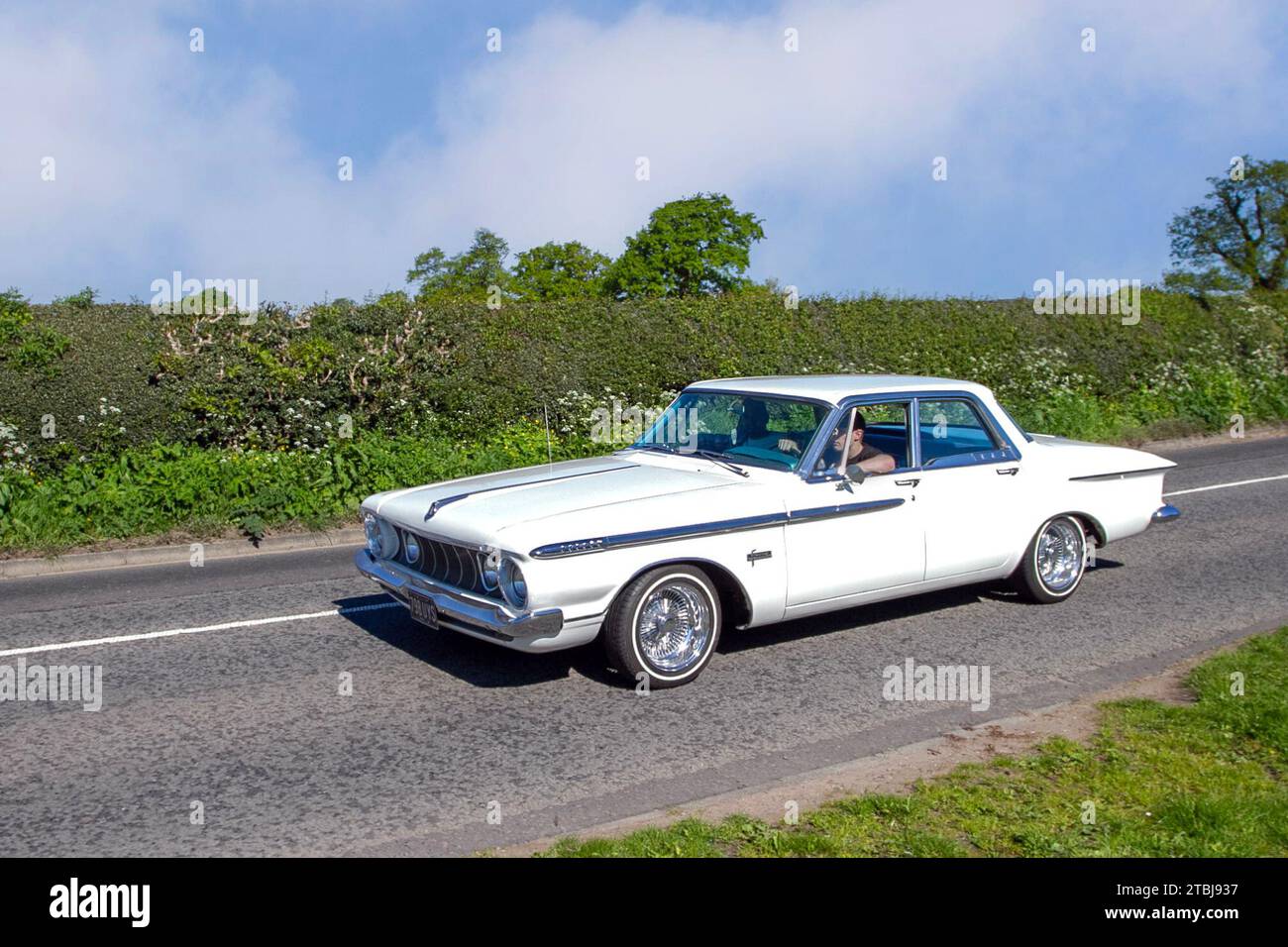 1961 60s sixties American White Chrysler Plymouth Sport Fury 383, four-door sedan with tail fins removed: Vintage, restored classic motors, automobile collectors motoring enthusiasts, historic veteran cars travelling in Cheshire, UK Stock Photo