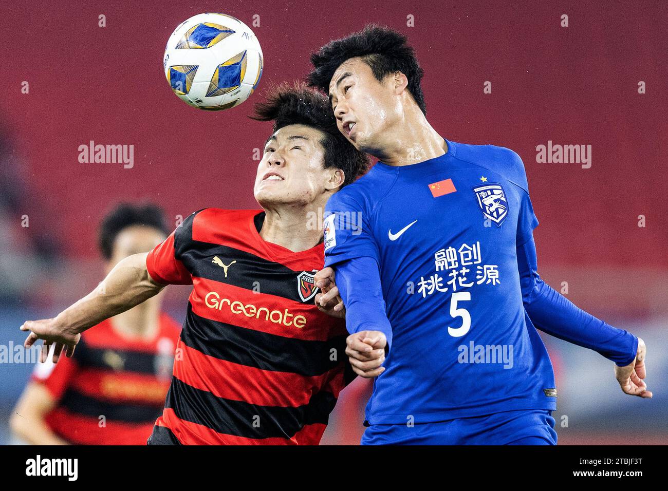 Wuhan, China. 06th Dec, 2023. Lee Ho-jae #33 (L) of Pohang Steelers and Park Ji-soo #5 (R) of Wuhan Three Towns FC seen in action during the AFC Champions league football match between Wuhan Three Towns FC of China and Pohang Steelers of South Korea at Wuhan Sports Center Stadium. Final scores; Wuhan Three Towns FC of China 1-1 Pohang Steelers of South Korea. (Photo by RenYong/SOPA Images/Sipa USA) Credit: Sipa USA/Alamy Live News Stock Photo