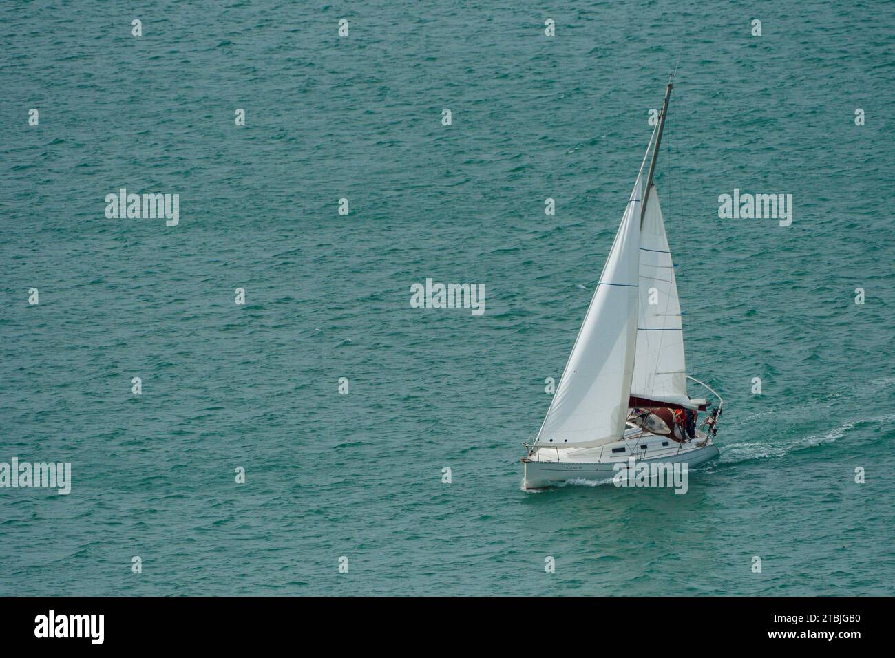 Sailboat sailing through the Cantabrian Sea in the Bay of Laredo Stock Photo