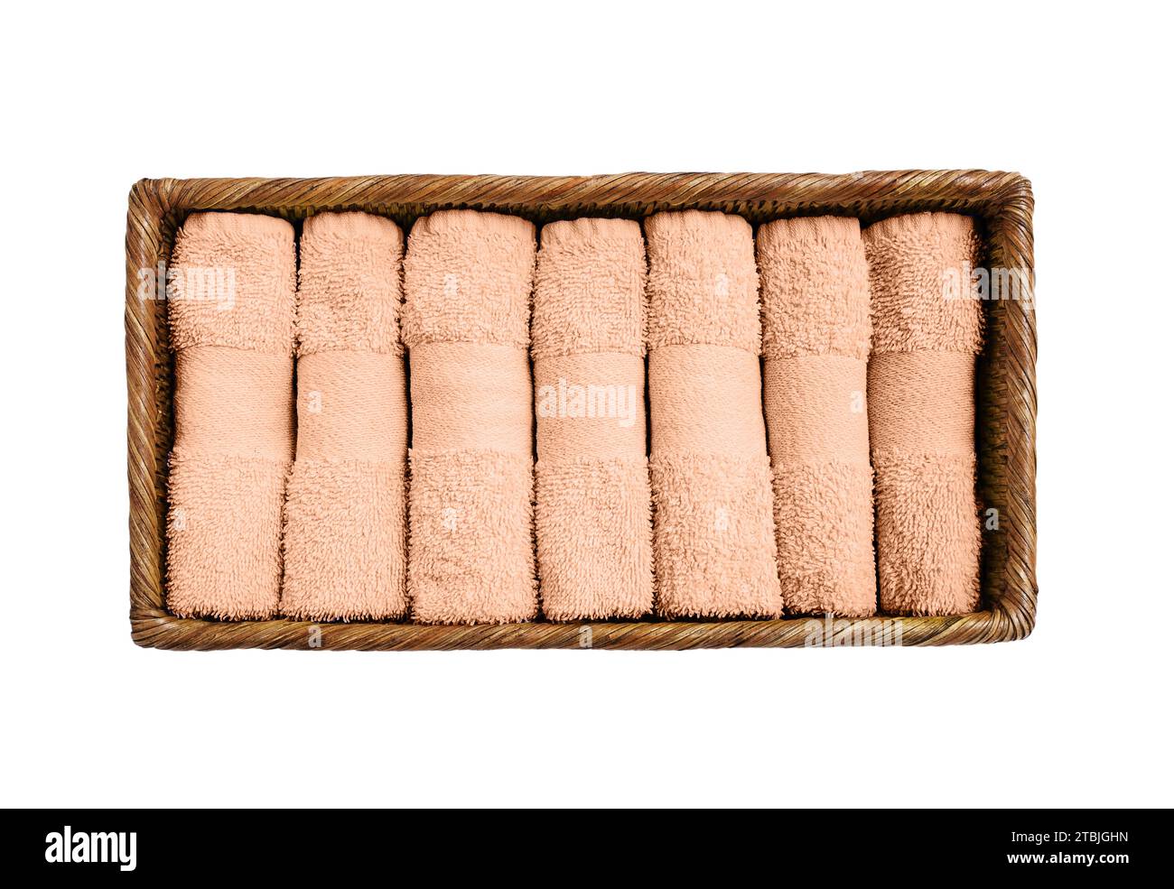 Peach color towels in basket isolated over white background. Color of