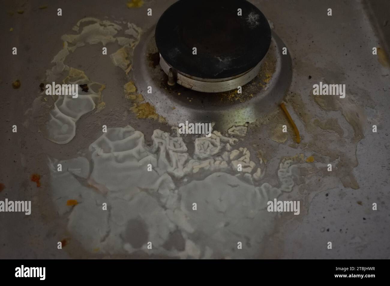 non edited photo of Dirty stove in the kitchen with food leftovers. Unclean gas kitchen cooktop with greasy spots, old fat stains, fry spots and oil Stock Photo