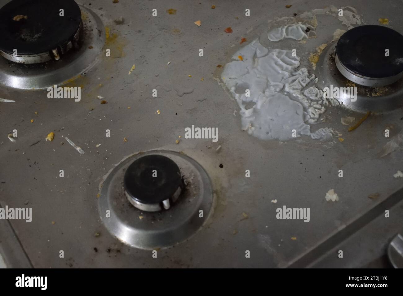 non edited photo of Dirty stove in the kitchen with food leftovers. Unclean gas kitchen cooktop with greasy spots, old fat stains, fry spots and oil Stock Photo