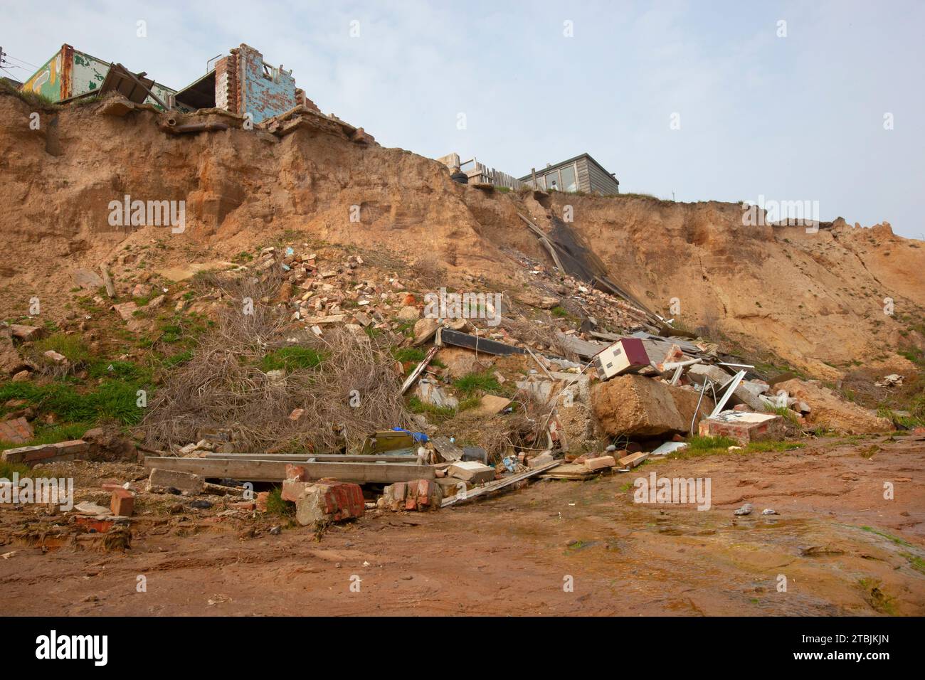 The beach at Happisburgh Norfolk with houses that have fallen into the sea due to coastal erosion March Stock Photo