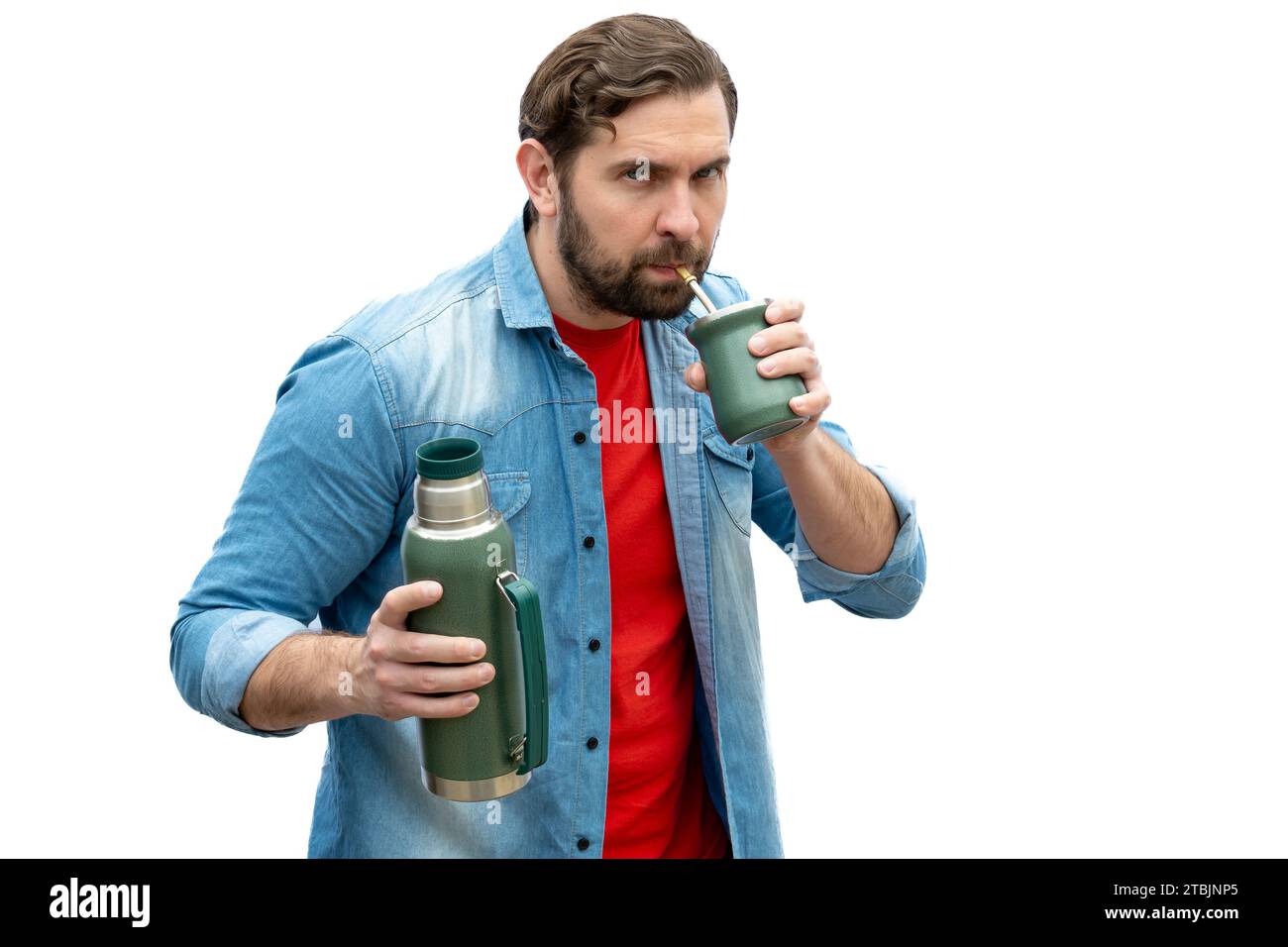 Young adult looking at camera while drinking mate. Stock Photo
