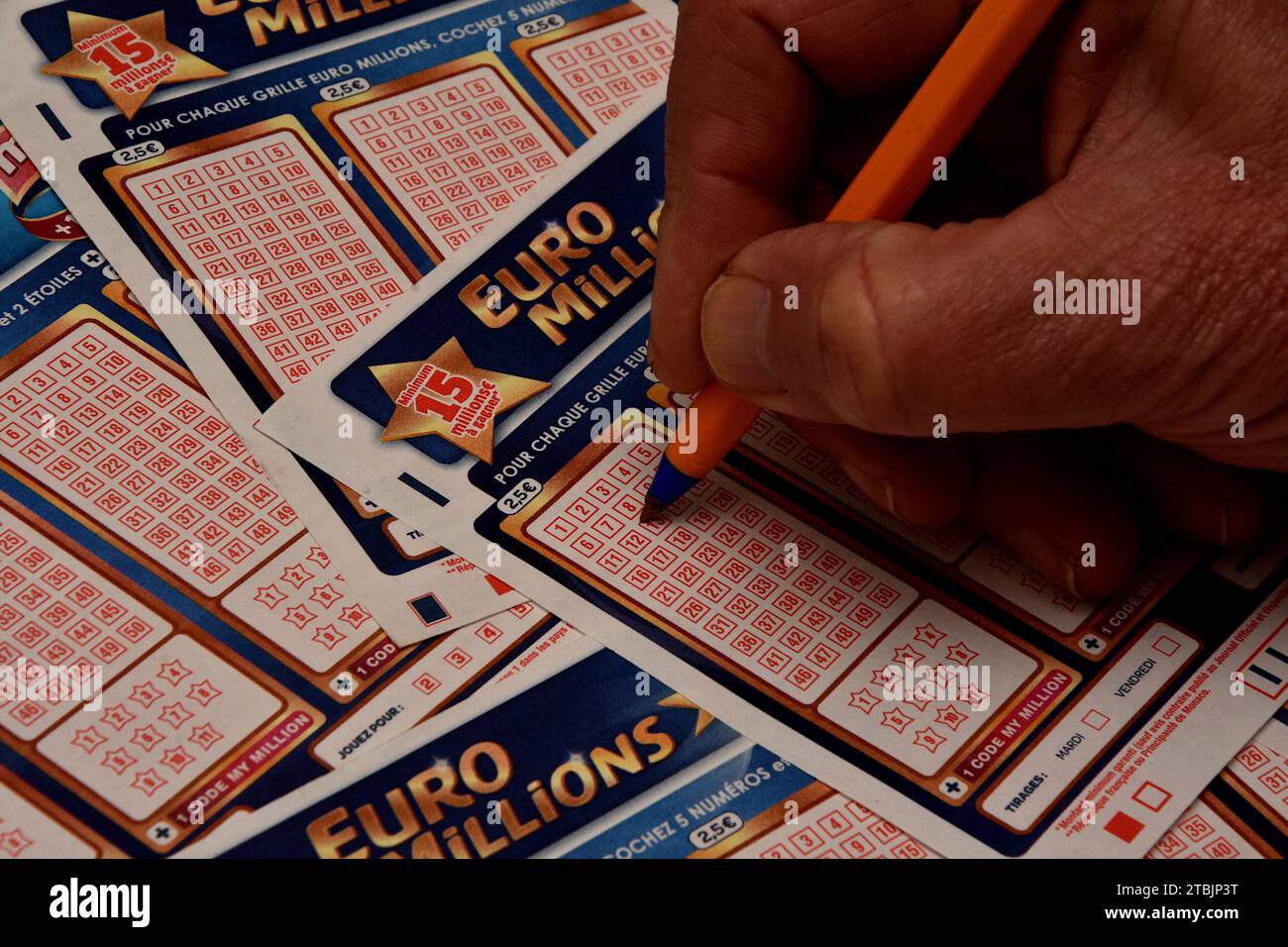 France. 07th Dec, 2023. In this photo illustration, a man is about to check a box on a grid of a EuroMillions game slip. A historic jackpot of 240 million euros will be put into play for the EuroMillions draw on Friday December 8, 2023. This is the largest sum ever put into play since the launch of the lottery in 2004. (Photo by Gerard Bottino/SOPA Images/Sipa USA) *** Strictly for editorial news purposes only *** Credit: Sipa USA/Alamy Live News Stock Photo