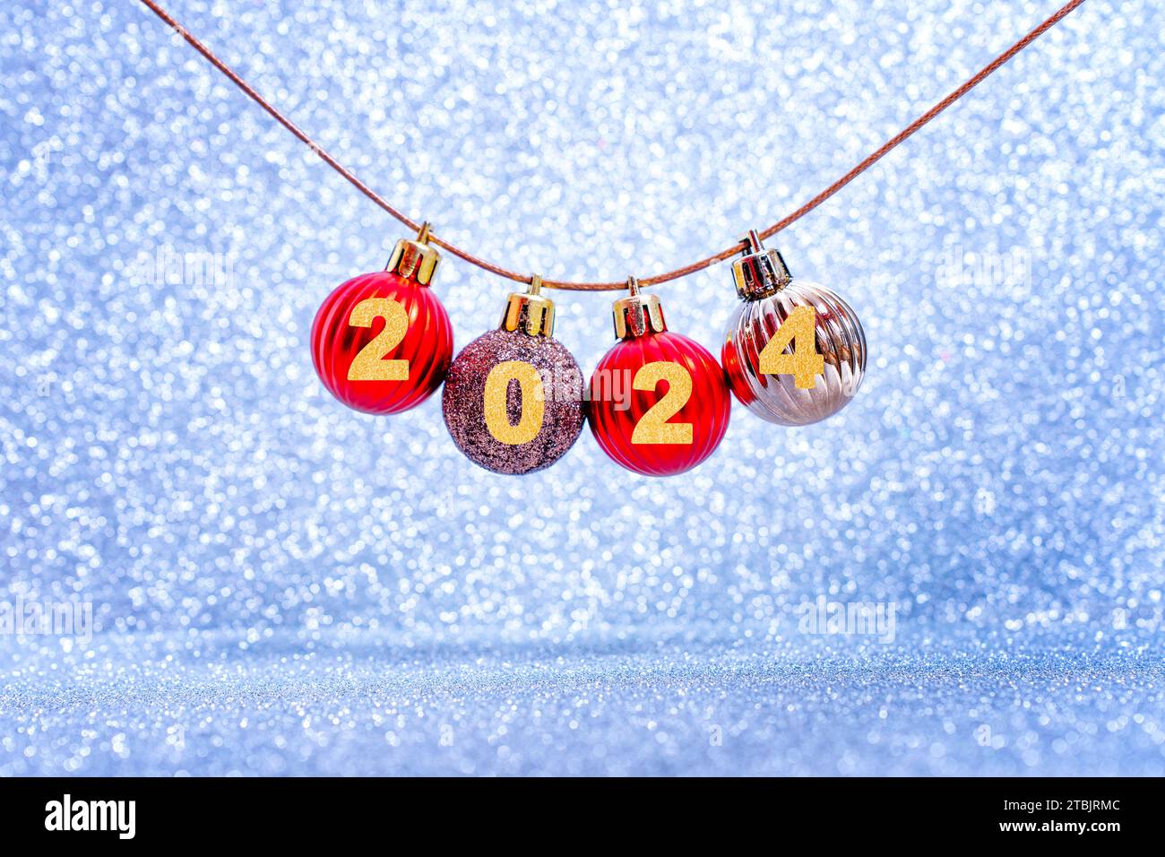 Miniature Christmas tree baubles strung together on a cord, adorned