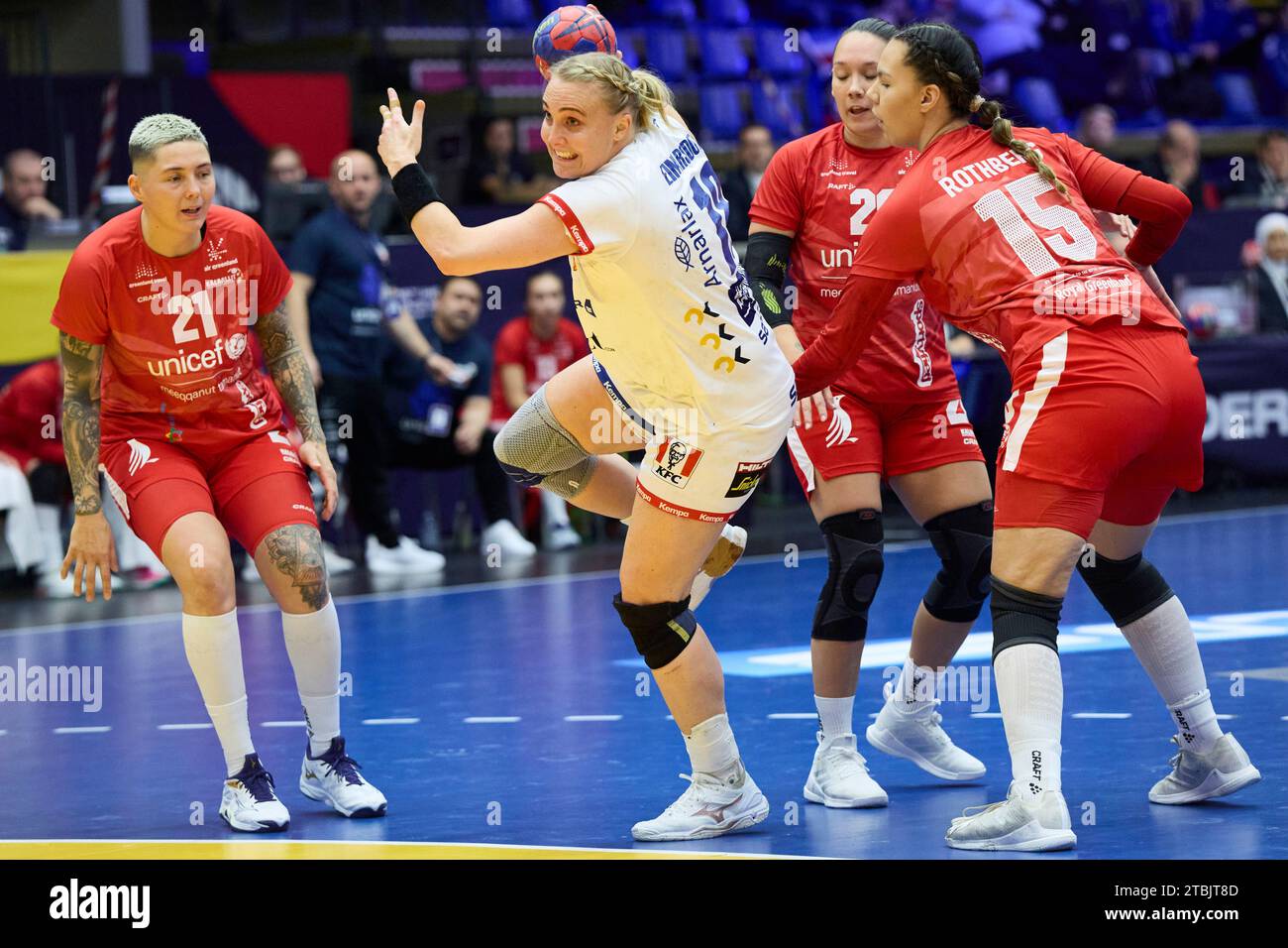 Icelands Hindinggunur Einardatter shoots in front of Greenlands Ali Pedersen, Sandra Rothberg, left, and Anja Heilmann during the IHF Presidents Cup handball match between Greenland and Iceland in Arena Nord in Frederikshavn, Denmark, Thursday December 7, 2023 Stock Photo