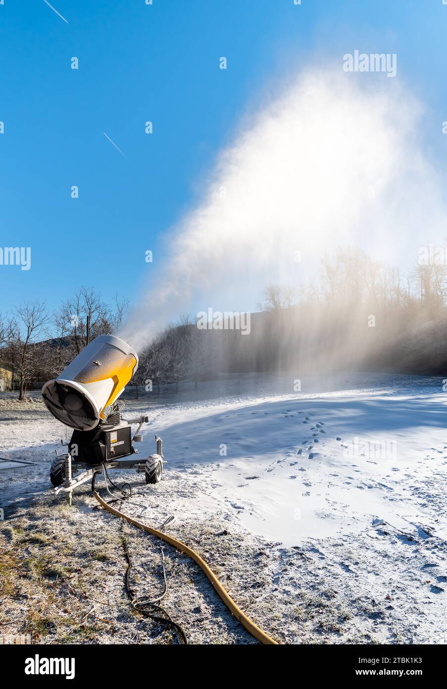 Snow cannon is producing artificial snow for ski slopes in Cunardo sky
