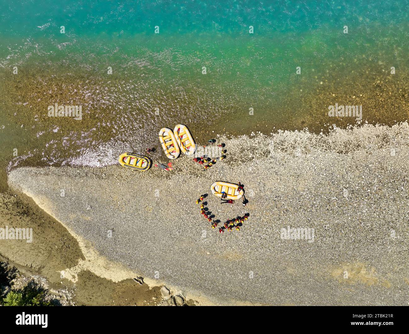 White water rafting. Vertical drone view of a group of yellow rafts and ...