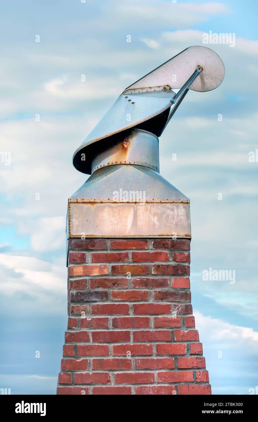 Wind directional swivel chimney cowl on a home brick chimney in Neskowin, Oregon along the shores of  the Pacific Ocean Stock Photo