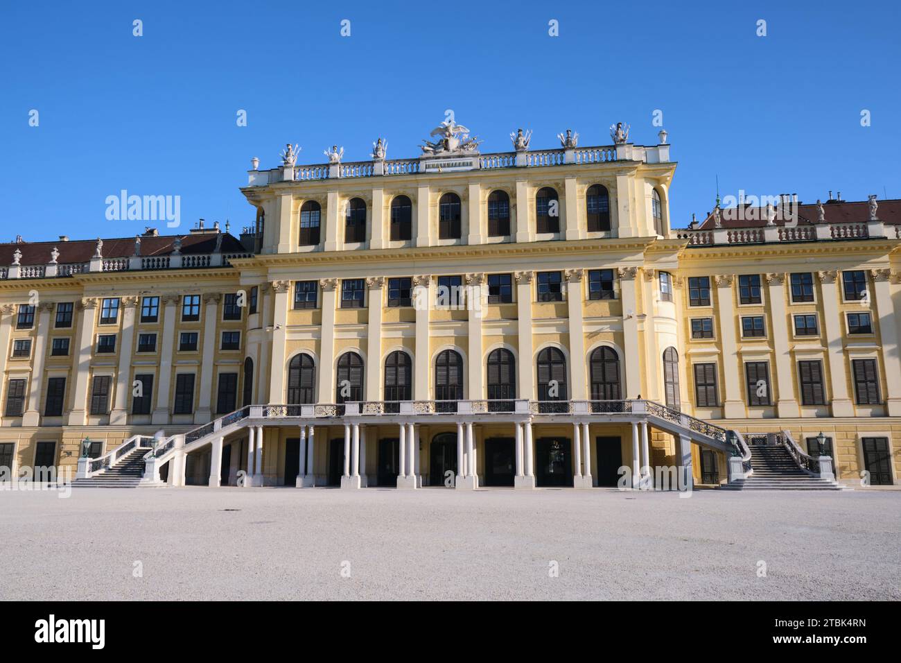 Schonbrunn palace back facade with visitors, on a blue sky day. Attraction, tourism. Vienna, Austria - September 28, 2023. Stock Photo