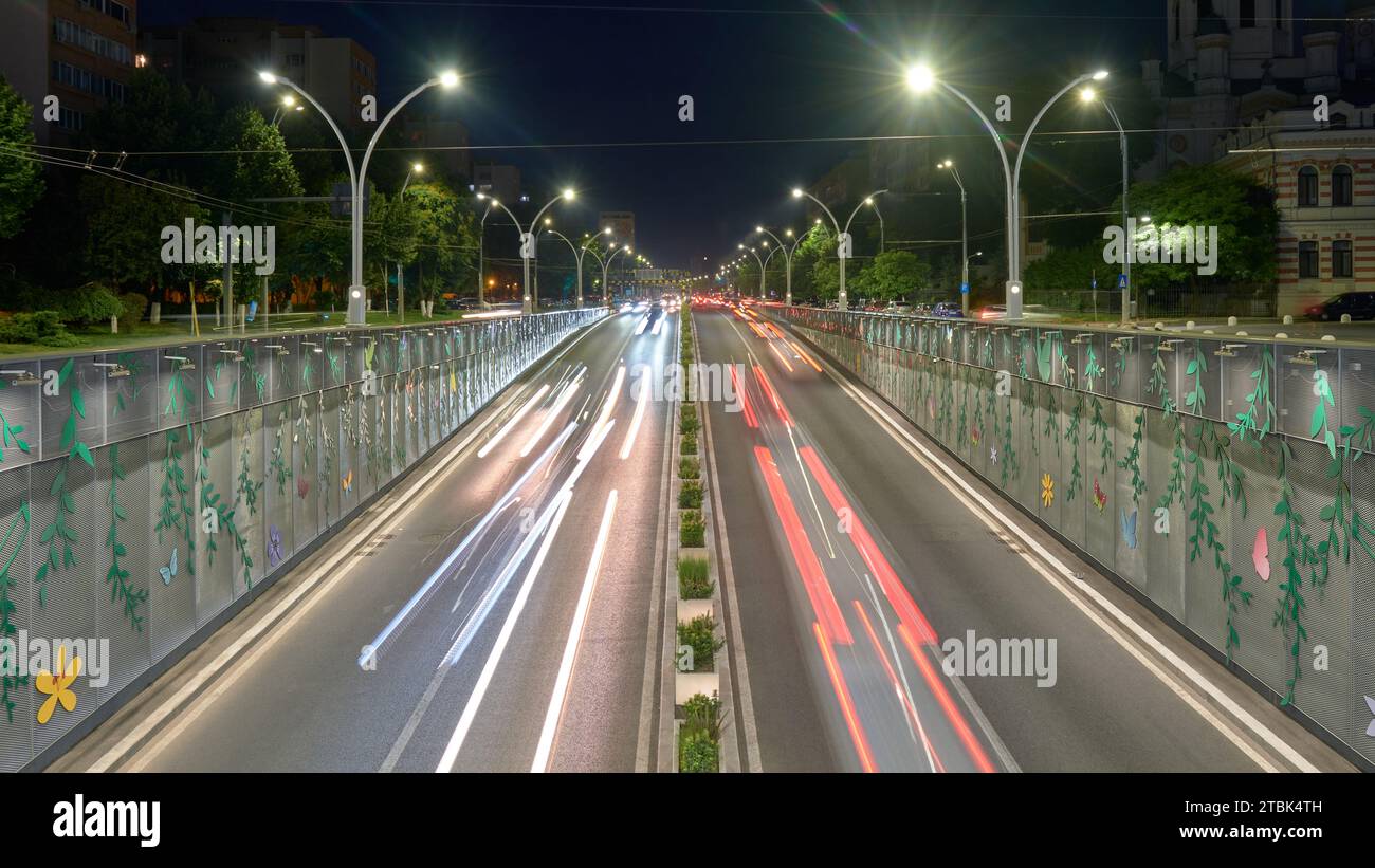 Underpass car traffic at night, with cars driving through an inner city tunnel called Pasajul Unirii, a landmark in Bucharest, Romania. Stock Photo