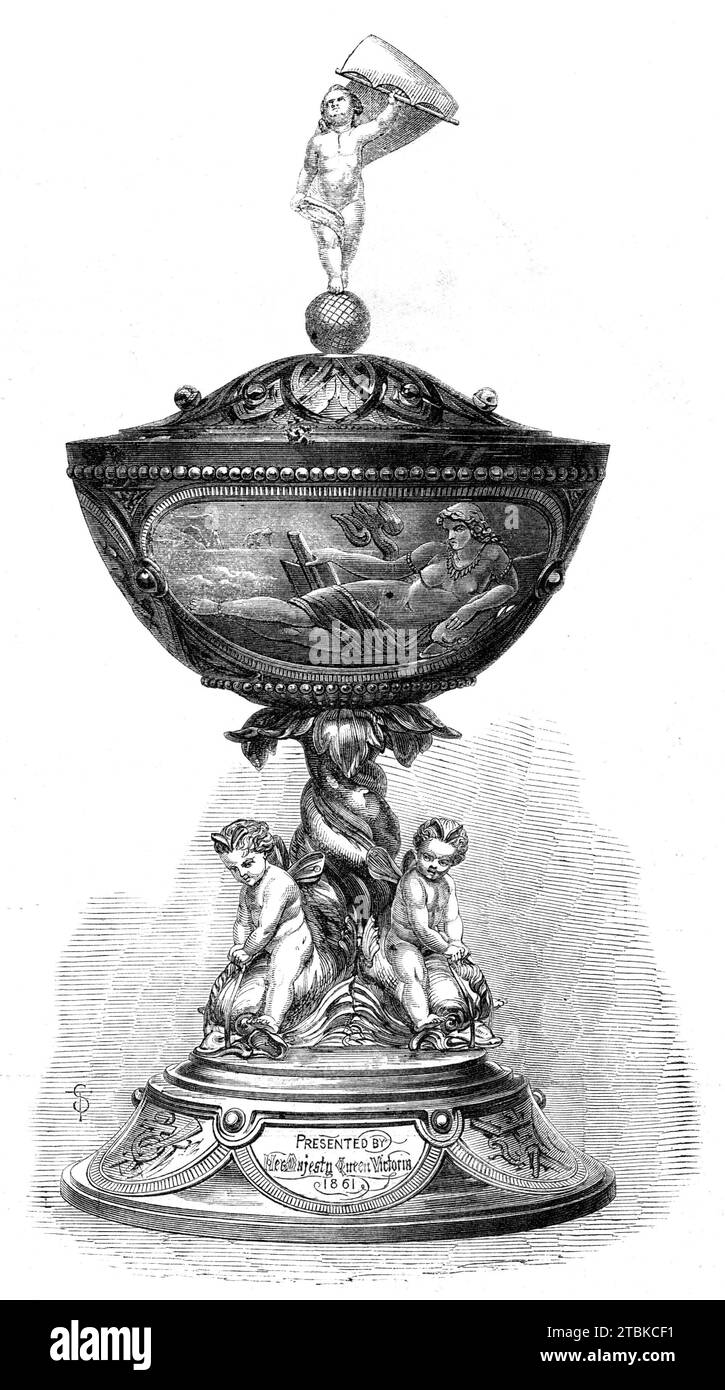 The Queen's Cup, won by Mr. Johnson's Audax at the Royal Western Yacht Club Regatta, 1861. 'Her Majesty has presented to the Royal Western Yacht Club a cup, which...was raced for on Thursday week, and won by Mr. Johnson's Audax...(The cup)...is massive and elegant, of artistic conception, and of perfect finish. It is supported by the tails of three dolphins whose bodies form the stem, while infant sons of AEolus, seated on their shoulders, urge them to race. On the sides of the cup are three medallions - the Sea, represented by Amphitrite; the Earth, by Cybele; and science, by Minerva. The cov Stock Photo