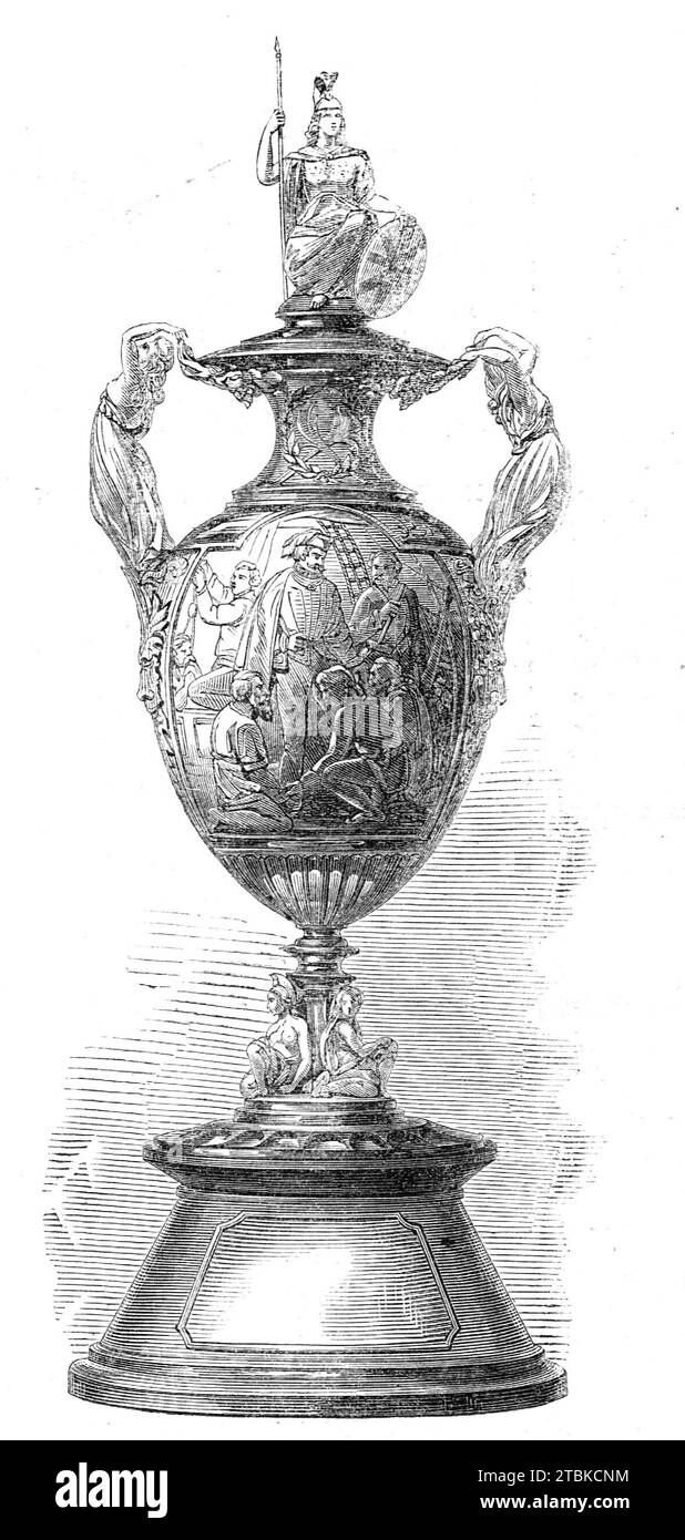 Challenge Cup presented to the Royal Canadian Yacht Club by the Prince of Wales, 1861. 'The execution of this splendid trophy was intrusted to the well-known house of Messrs. Hunt and Roskell, and it is a triumph of the silversmith's art. It consists of a vase in frosted silver, partly burnished. Two principal medallions, in low relief, illustrate an incident in the life of Columbus, in which the great discoverer quells his mutinous sailors, and the cession of a tract of land (afterwards called Pennsylvania) to William Penn. Two graceful female figures form the handles of the cup, the cover of Stock Photo