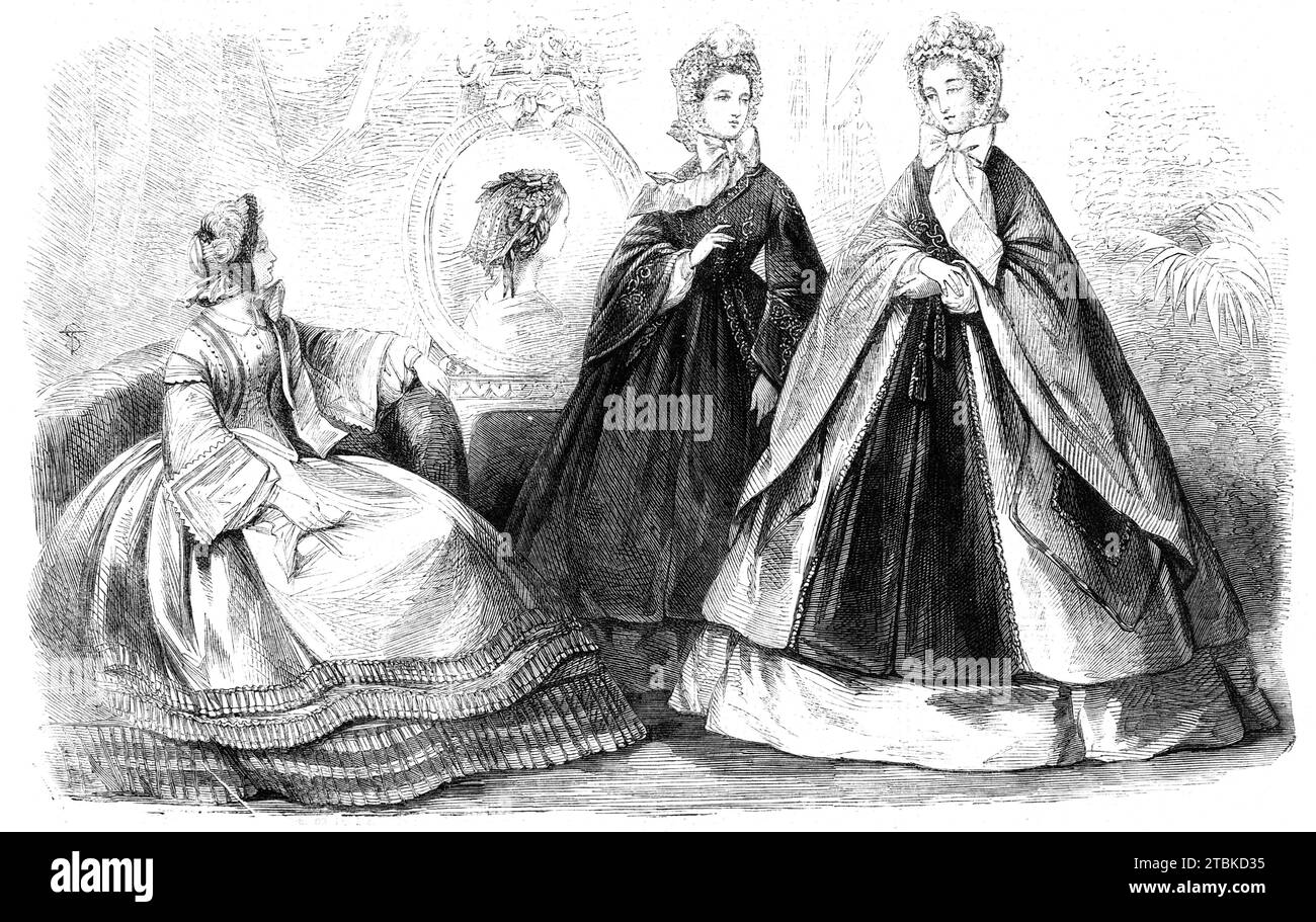Paris fashions for November, 1861. '1. The Manteau Marchesa...the facings and ornaments are of velvet, and the edges are bordered with narrow plain silk trimming; the hood is composed of velvet edged with crape. The robe of this toilet is of velours &#xe9;pingle; and the bonnet of green silk...surmounted by roses, over which the feathers...are made to fall gracefully. 2. The Manteau Hongrois. This cloak is composed principally of velvet-pile cloth...the sleeves and the cuffs are bordered with a satin cording. Plain silk dress; bonnet of white taffetas piqu&#xe9;, ornamented with a feather...th Stock Photo