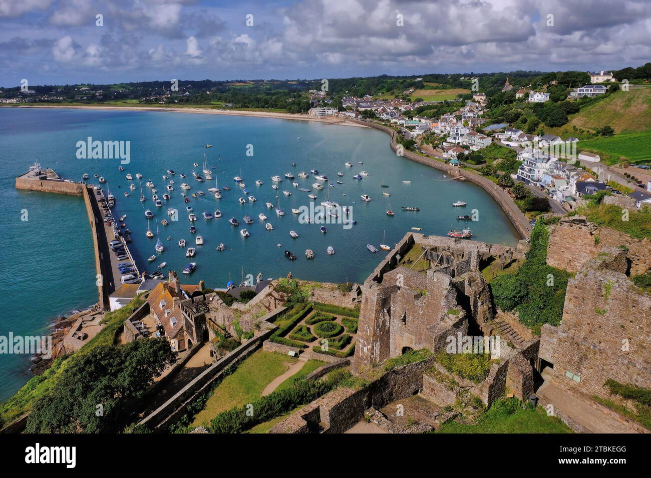 Gorey: Village, boats, pier and turquoise sea from Mont Orgueil Castle, Gorey, Jersey, Channel Islands, UK Stock Photo