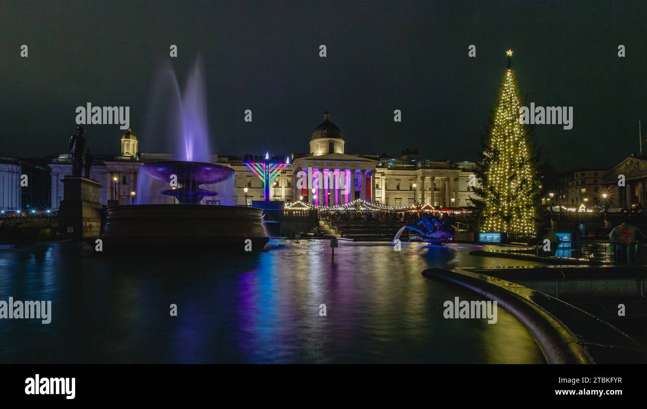 The newly lit christmas tree in Trafalgar Square alongside the menorah