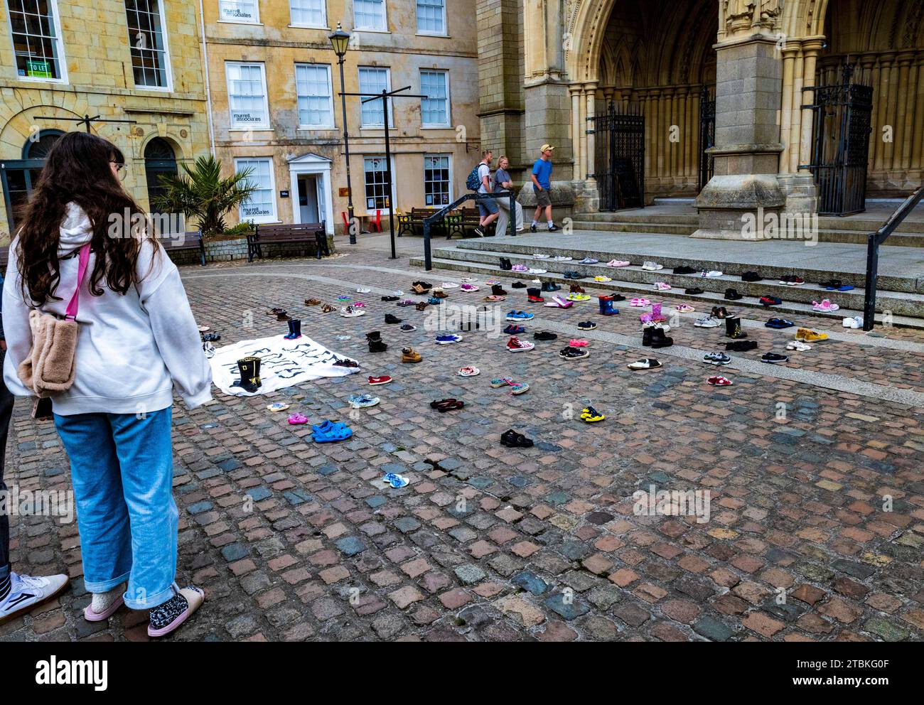 'We’ve abandoned these shoes outside Truro Cathedral like our MPs have abandoned child refugees” - The shoes represent refugee family separation. Stock Photo