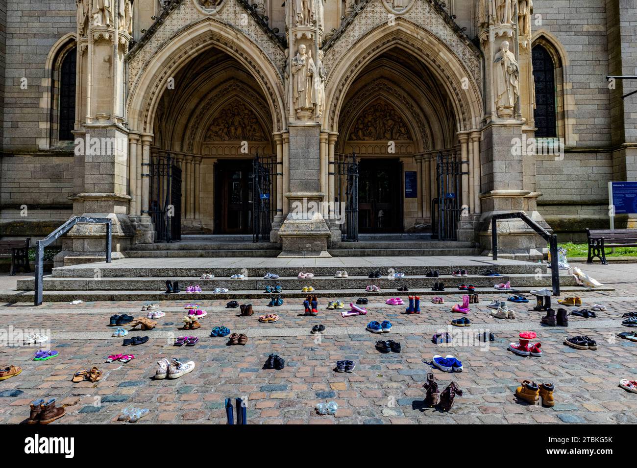 'We’ve abandoned these shoes outside Truro Cathedral like our MPs have abandoned child refugees” - The shoes represent refugee family separation. Stock Photo