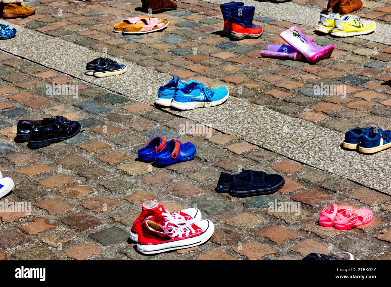 'We’ve abandoned these shoes outside Truro Cathedral like our MPs have abandoned child refugees” - The shoes represent refugee family separation. Stock Photo