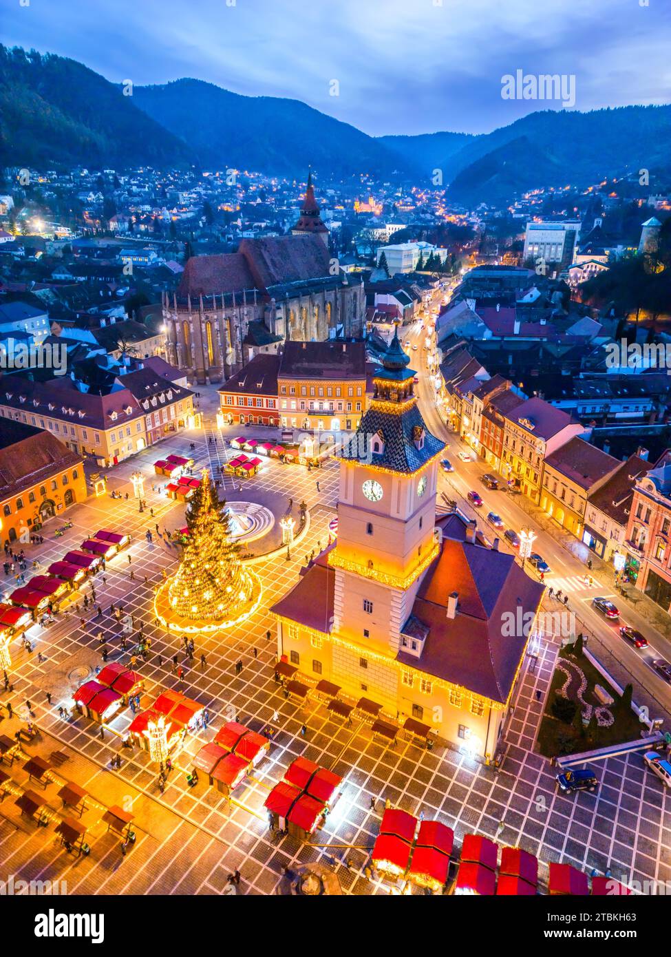 Brasov, Romania. Christmas Market, twilight beautiful lights, aerial drone view with Main Square, Transylvania holiday destination. Stock Photo