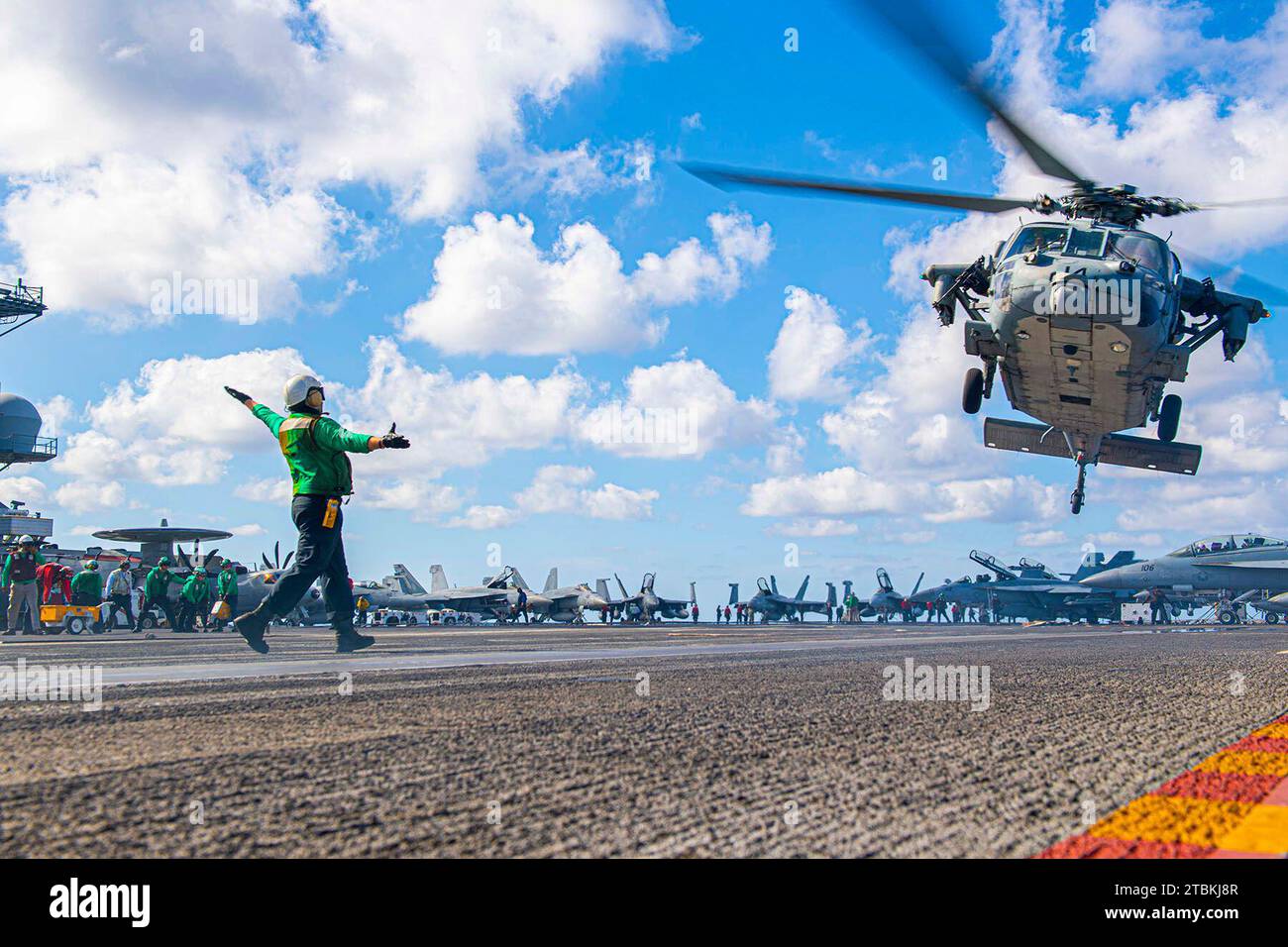 At Sea. 30th Oct, 2023. U.S. Navy Airman Ian Teitelbaum signals takeoff for an MH-60S Sea Hawk helicopter, attached to the Dusty Dogs of Helicopter Sea Combat Squadron (HSC) 7, aboard the aircraft carrier USS Dwight D. Eisenhower (CVN 69) Oct. 30, 2023. The Dwight D. Eisenhower Carrier Strike Group is currently operating in the Mediterranean Sea, at the direction of the Secretary of Defense. The U.S. maintains forward-deployed, ready, and postured forces to deter aggression and support security and stability around the world. (Credit Image: © Janae Chambers/U.S. Navy/ZUMA Press Wire) EDITO Stock Photo
