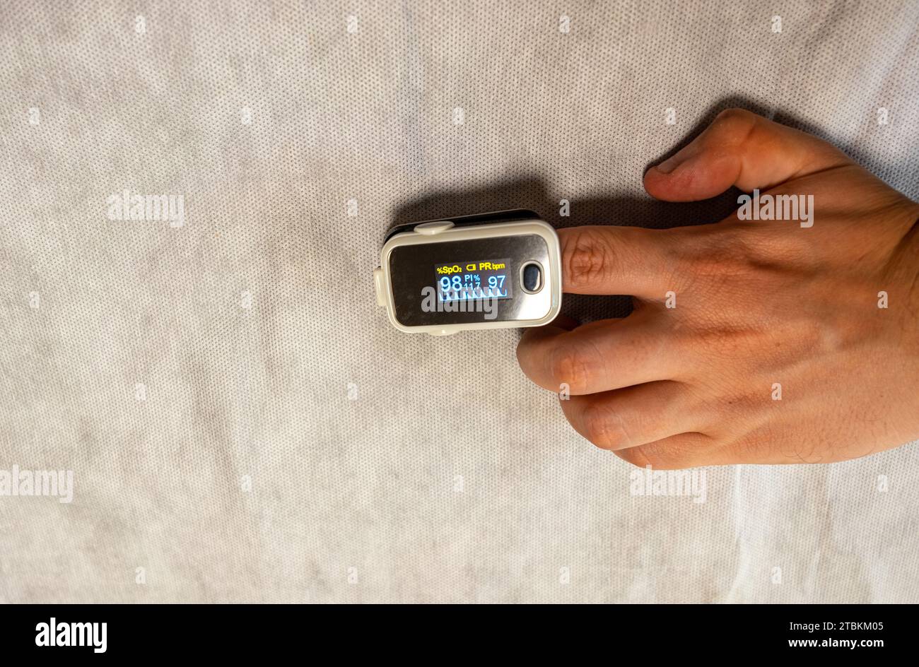 hand using an oximeter on a white background Stock Photo