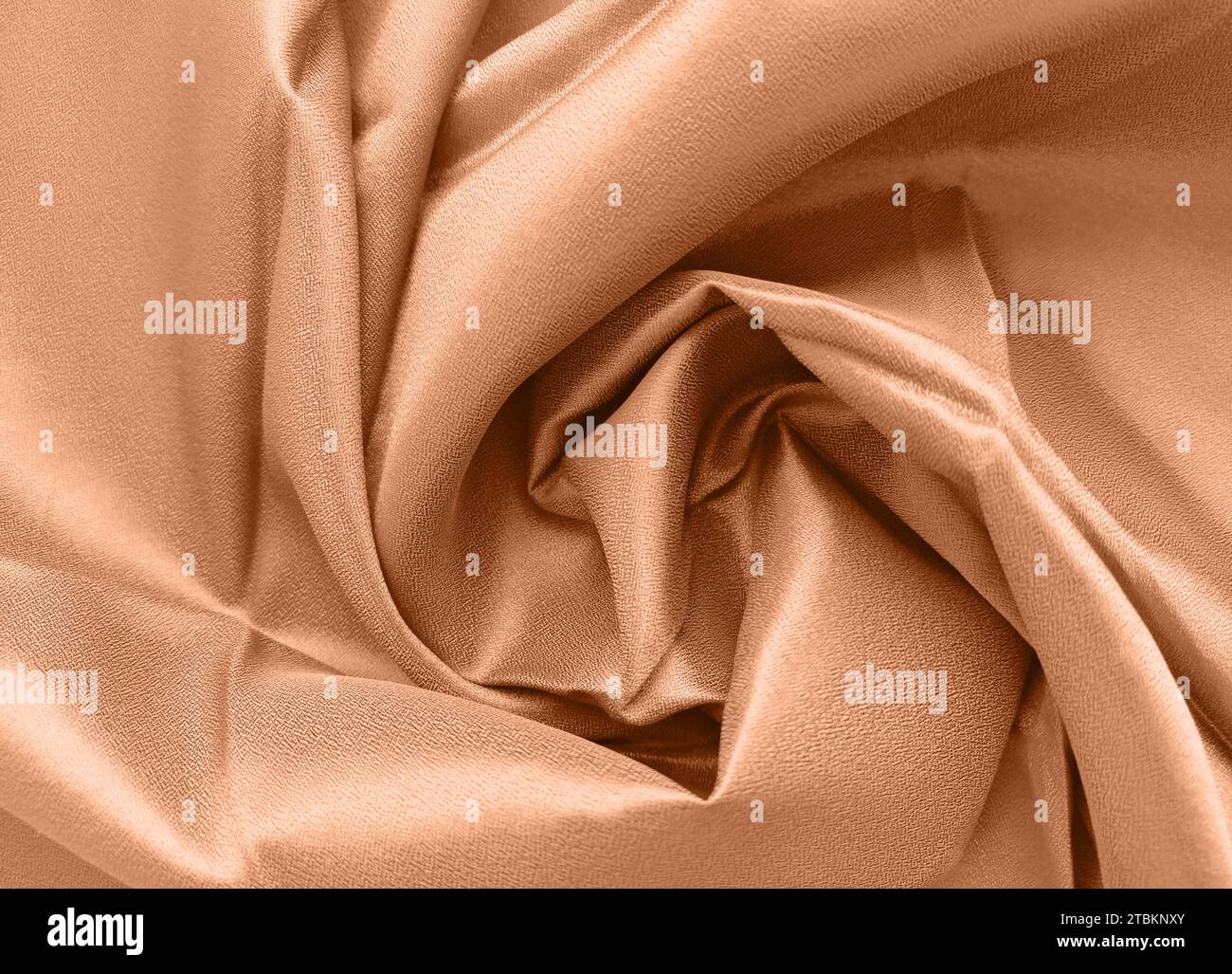 Peach fuzz is the color of the year 2024. Silk fabric folded with ...