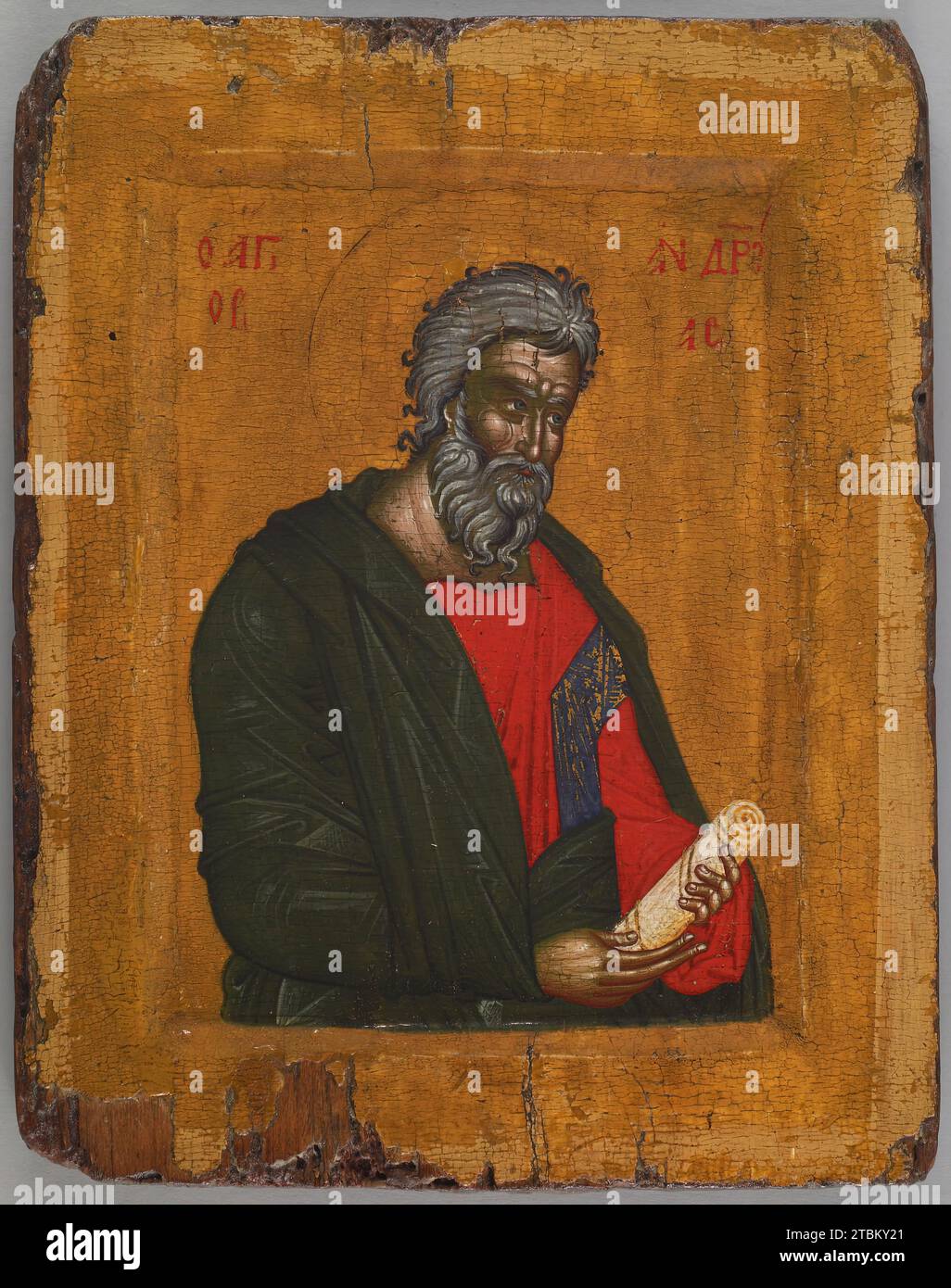 Saint Andrew, 14th century. Saint Andrew, holding a scroll, looks intently to his left, indicating that the panel once may have formed part of a group of icons with Christ at the center. It may have been placed on the upper tier of an &quot;iconostasis,&quot; the screen dividing the sanctuary from the nave in an Orthodox Church. The color scheme of the icon is unusual in its use of extremely bright colors for the saint's robe and a mustard yellow - instead of gold - for the background. Stock Photo