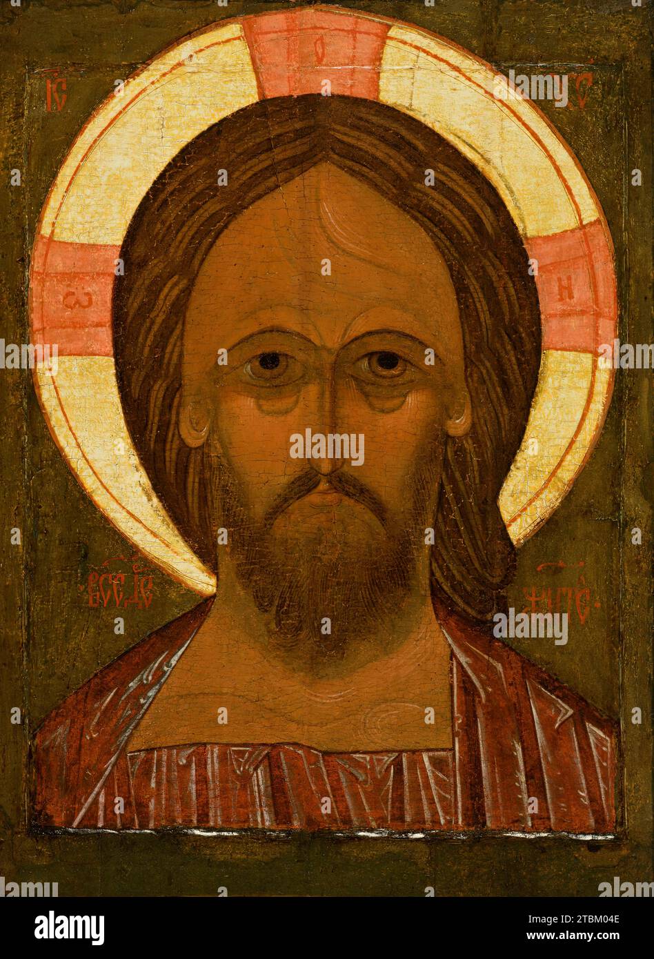 Christ Pantokrator, 16th century. Such large, powerful portraits of Christ &quot;Pantokrator&quot; (almighty) were customarily displayed on the iconostasis, or icon screen, separating the lay people in the nave from the altar area of the church. The use of an iconostasis, as well as this type of portrait icon, were adopted from Byzantium. In style, however, the icon is distinctly Russian, with Christ's large, heavily shadowed eyes and straight, narrow nose contributing to a stern expression appropriate to his role as Judge and Ruler. Stock Photo