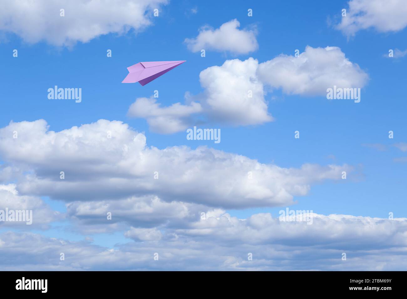 Violet paper plane flying in blue sky with clouds Stock Photo - Alamy