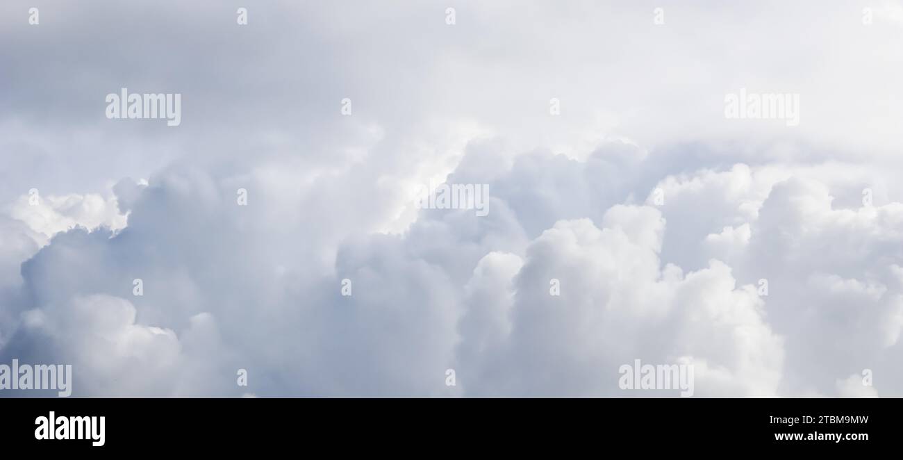 Cloudy sky background with sunlight shining through the white clouds Stock Photo