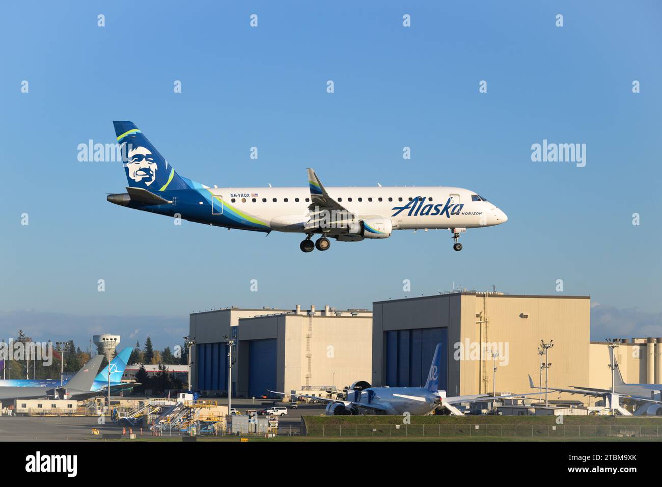 Everett, WA, USA - November 11, 2023; Alaska Airlines Horizon Embraer E175LR aircraft landing in front of Boeing factory Stock Photo