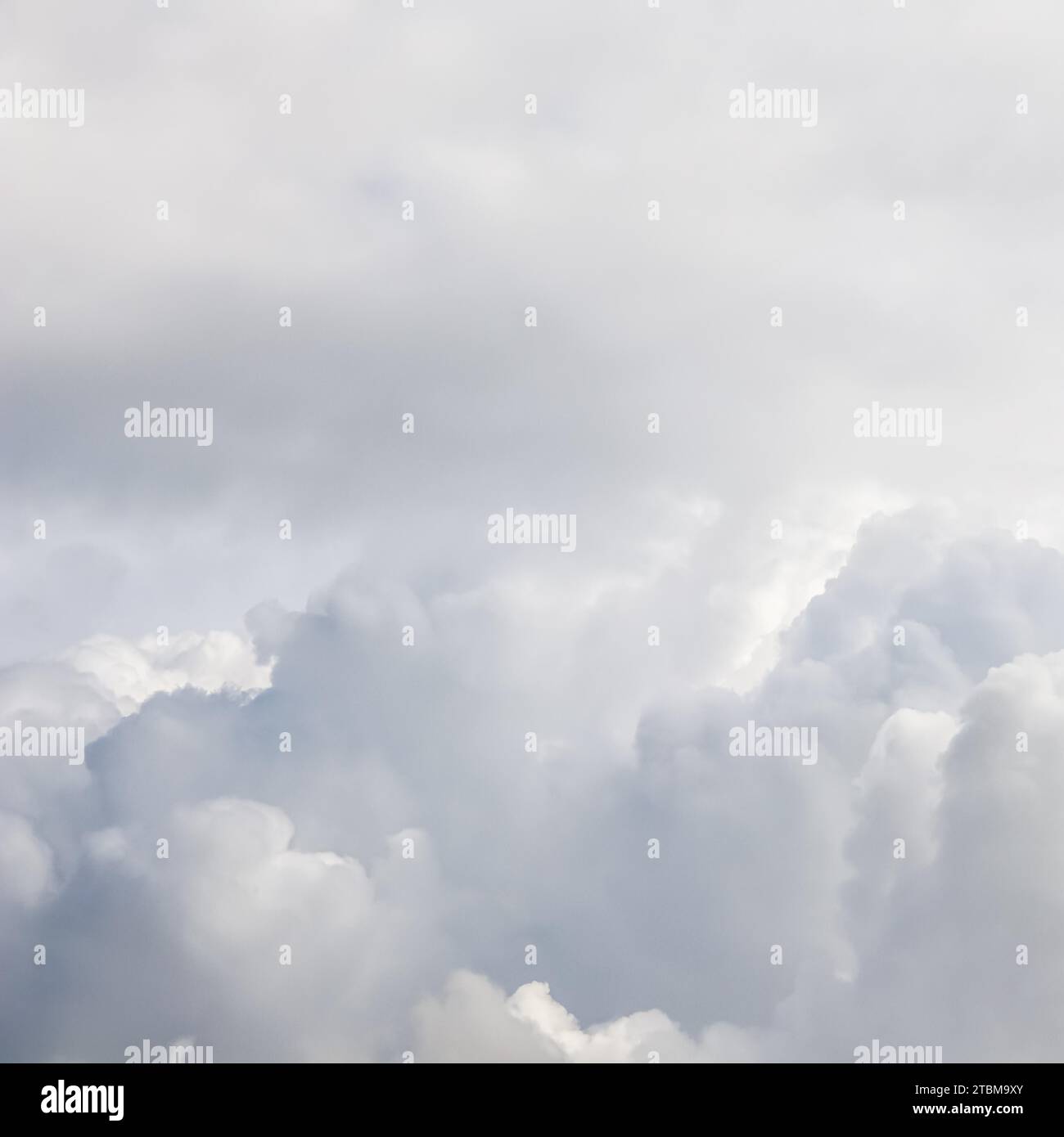 Cloudy sky background with sunlight shining through white clouds. Natural backdrop Stock Photo