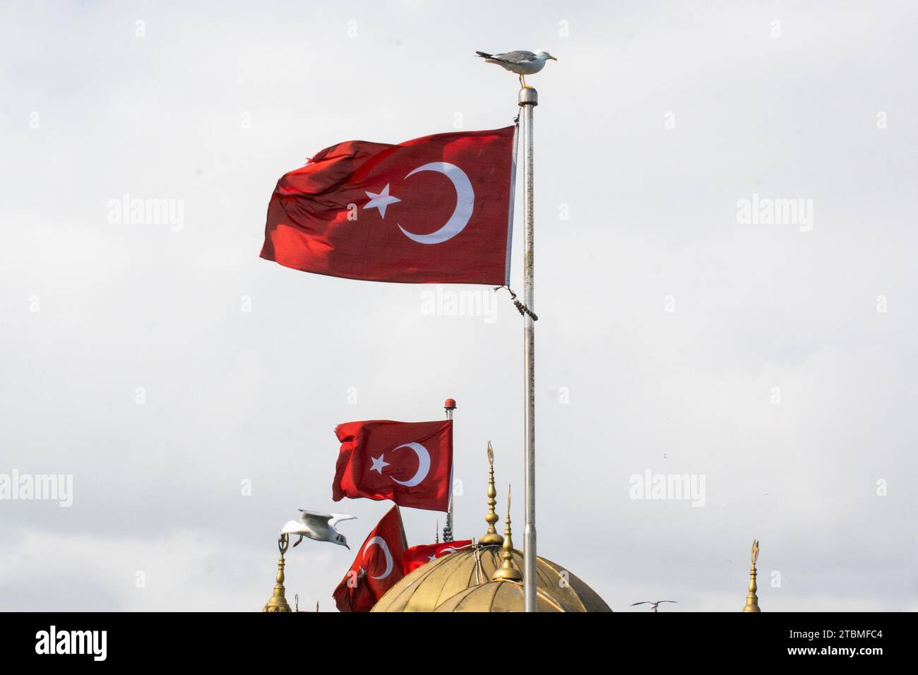 Turkish national flag with white star and moon on a pole in sky Stock