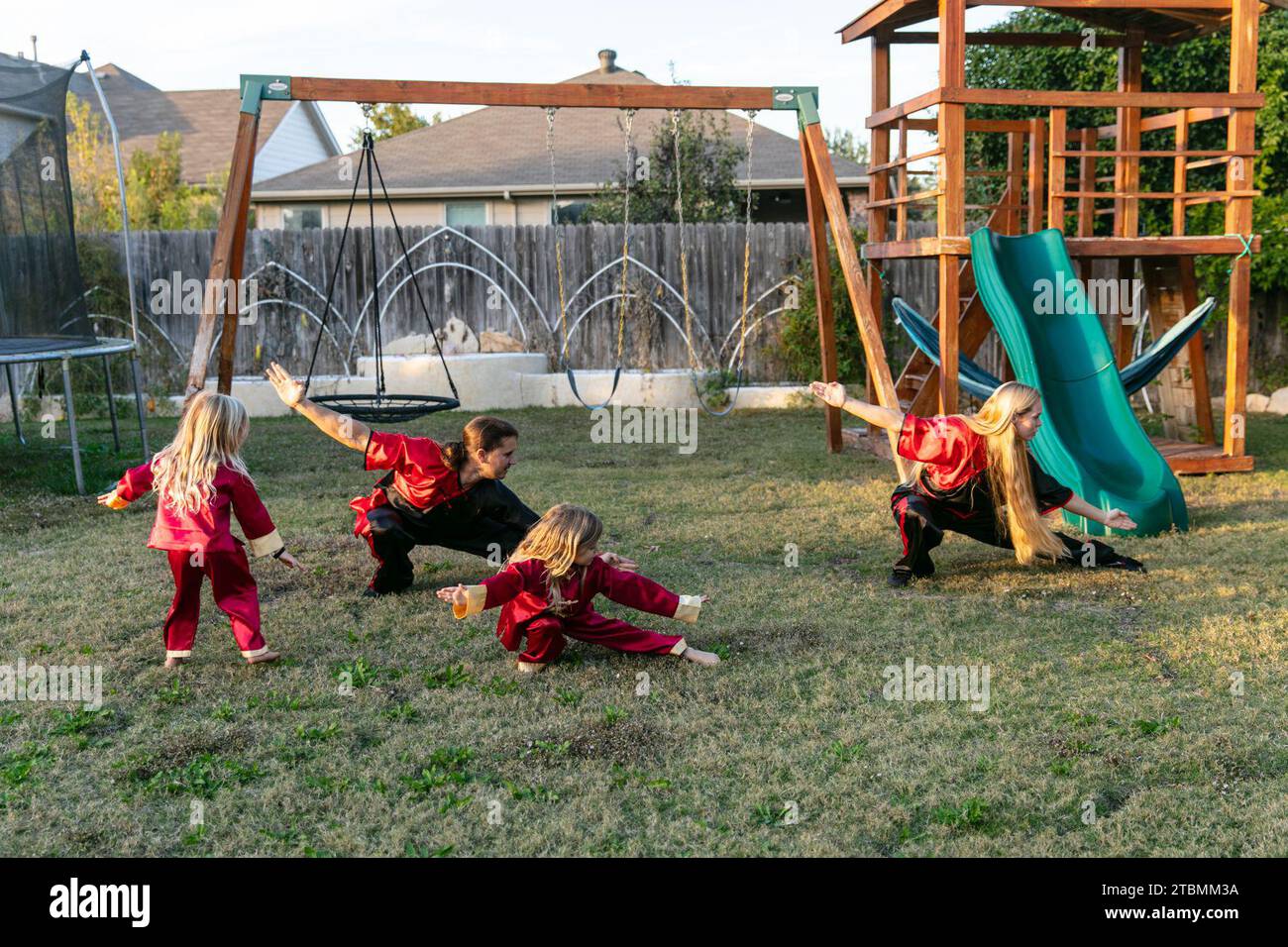 Fort Worth, USA. 18th Nov, 2023. David Saucedo (2nd L) and his wife Angela Saucedo (1st R) practice Wushu with their children at the backyard of their home, in Fort Worth, Texas, the United States, Nov. 18, 2023. TO GO WITH 'Feature: Love journey of U.S. Wushu family' Credit: Tian Dan/Xinhua/Alamy Live News Stock Photo