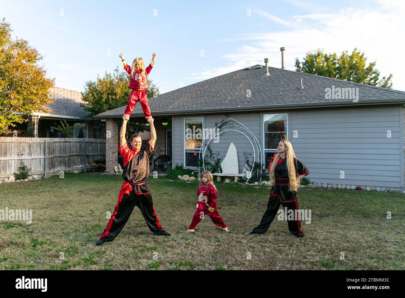 Fort Worth, USA. 18th Nov, 2023. David Saucedo (L, below) and his wife Angela Saucedo (R) practice Wushu with their children at the backyard of their home, in Fort Worth, Texas, the United States, Nov. 18, 2023. TO GO WITH 'Feature: Love journey of U.S. Wushu family' Credit: Tian Dan/Xinhua/Alamy Live News Stock Photo