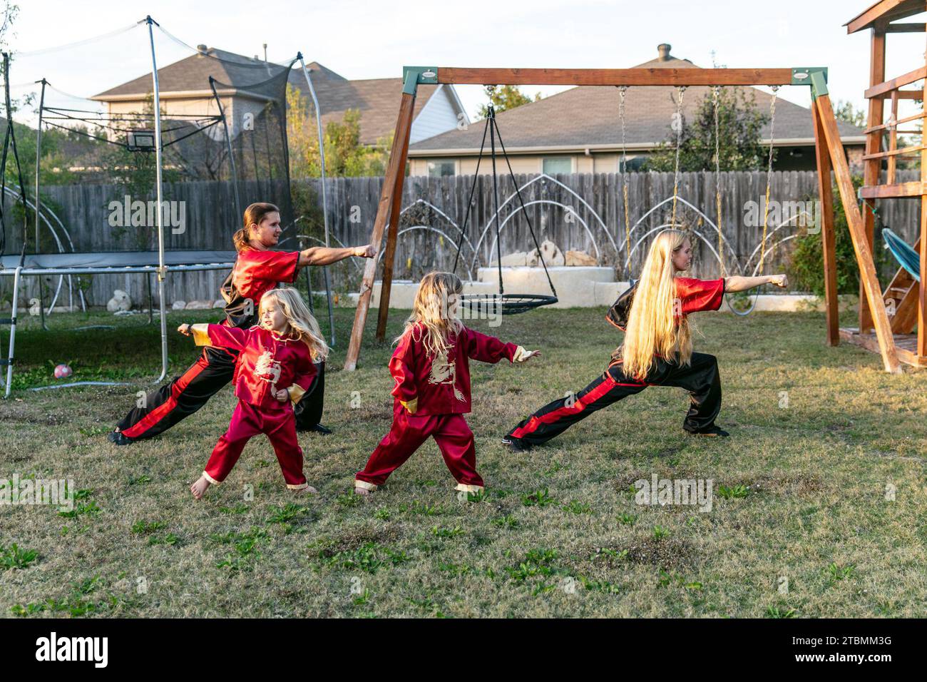 Fort Worth, USA. 18th Nov, 2023. David Saucedo (1st L) and his wife Angela Saucedo (1st R) practice Wushu with their children at the backyard of their home, in Fort Worth, Texas, the United States, Nov. 18, 2023. TO GO WITH 'Feature: Love journey of U.S. Wushu family' Credit: Tian Dan/Xinhua/Alamy Live News Stock Photo
