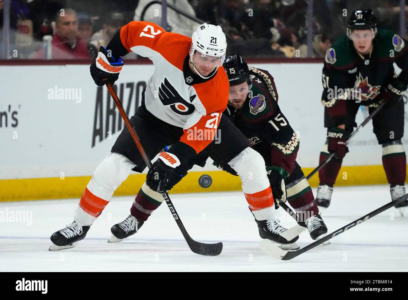 Philadelphia Flyers center Scott Laughton (21) gets to the puck before Arizona Coyotes center