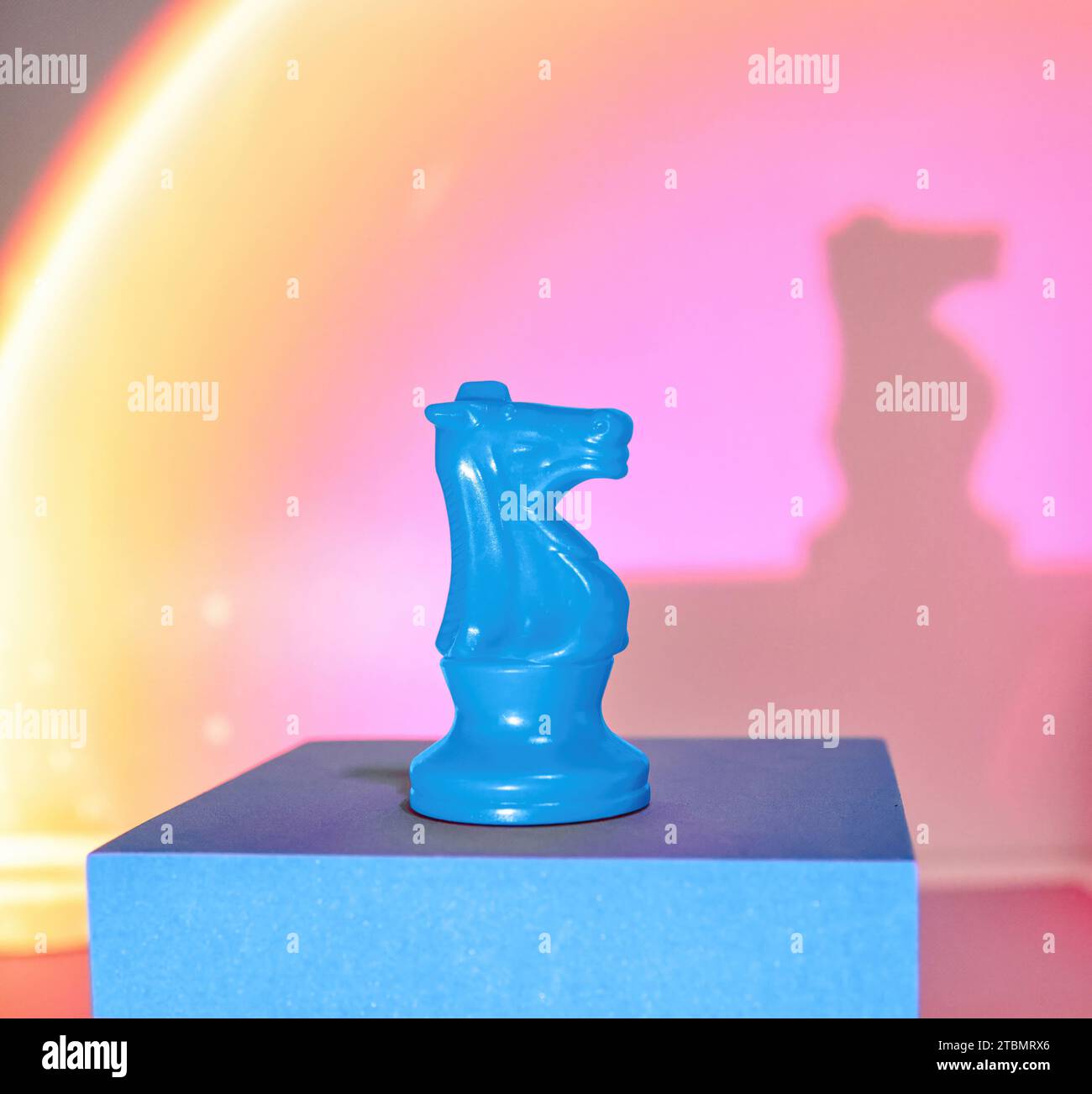 Single Knight Blue Chess Boardgames Piece on a Pastel, Ethereal, Dreamy Sunset Background Stock Photo