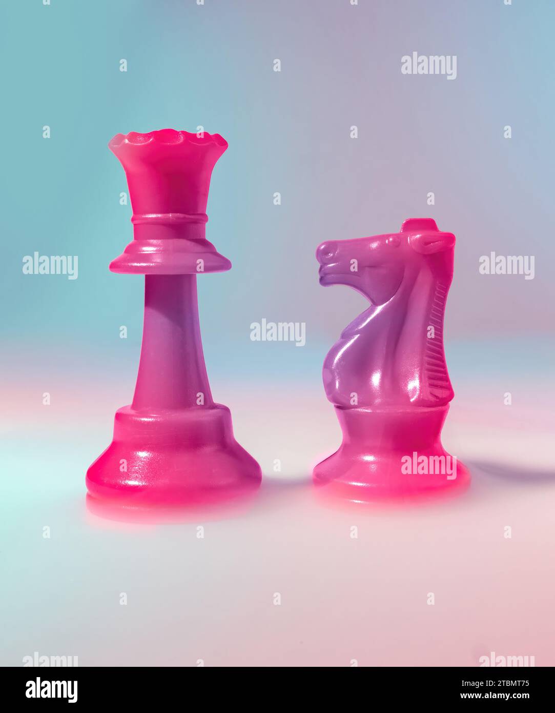 A Queen and an Knight Gradient Chess Game Piece on a Bed of Dramatic