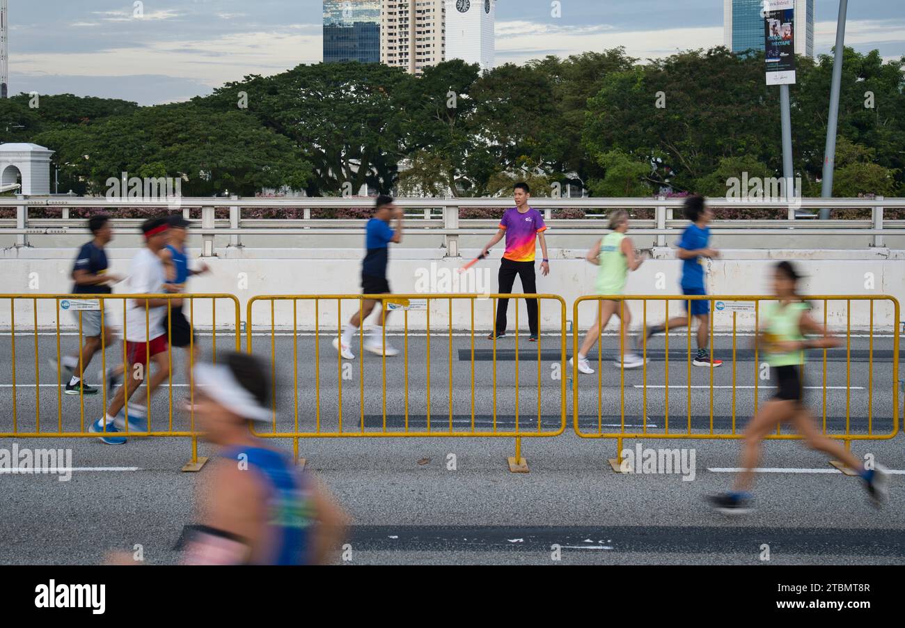 Singapore Dec 2, 2023 Race marshal guiding the runners during the