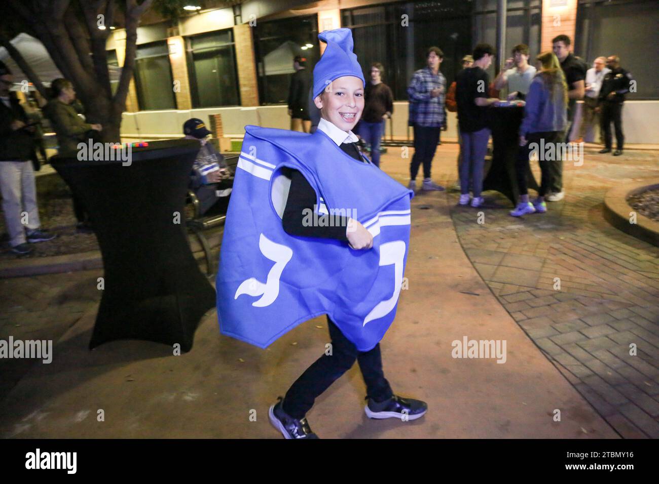 Son of ASU Chabad Rabbi Shmuel Tiechtel is dressed as a dreidel at the second annual Menorah lighting ceremony at Ragsdale-MLK Park in Tempe, Arizona on December 7, 2023. On the first night of Hanukkah, families engage in the tradition of lighting the Menorah which is a symbolic eight-branched candelabrum. (Photo By: Alexandra Buxbaum/Sipa USA) Credit: Sipa USA/Alamy Live News Stock Photo